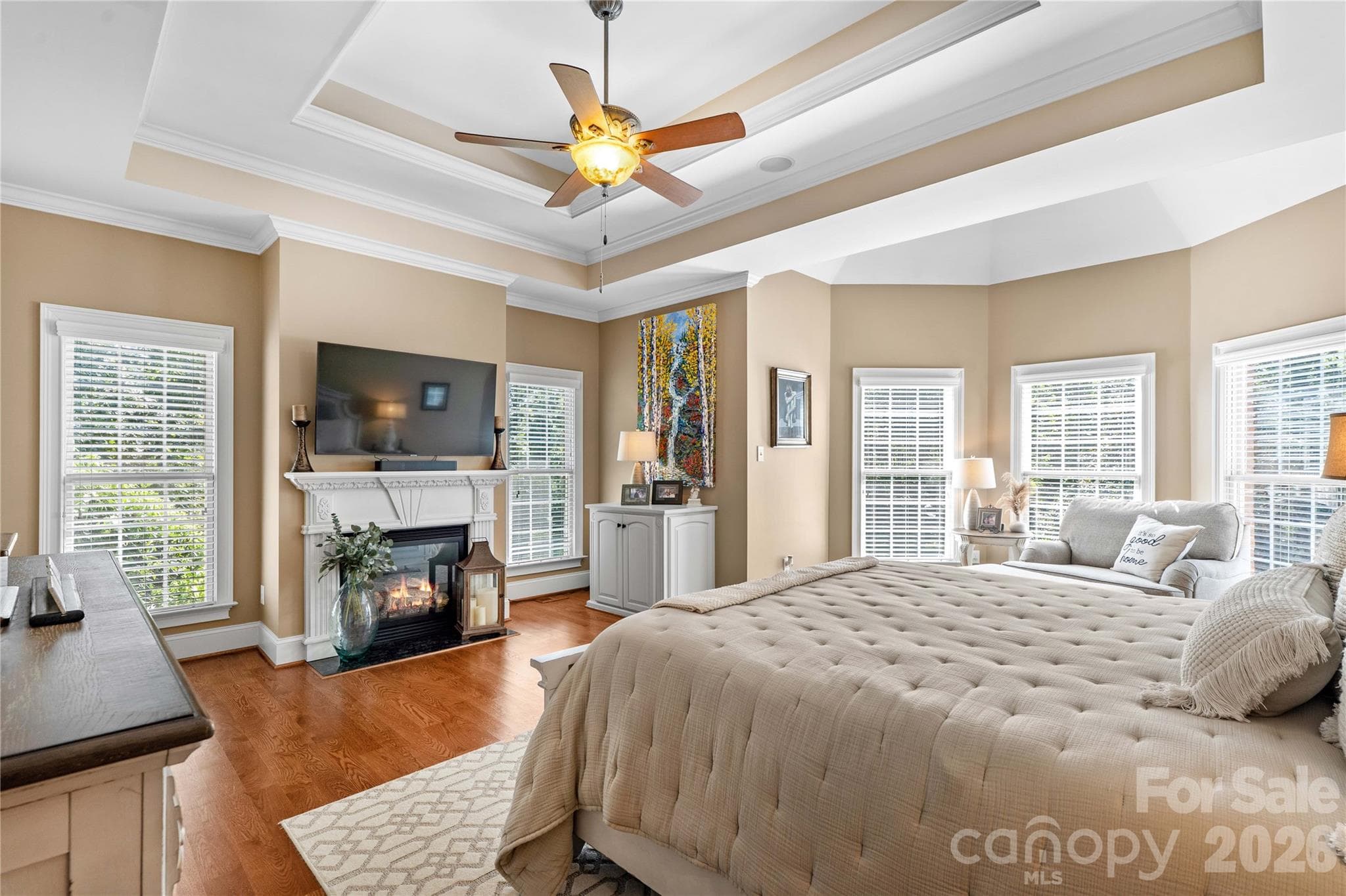 Large primary bedroom on main floor with hardwoods and fireplace - 220 Cedar Lake Drive, Statesville