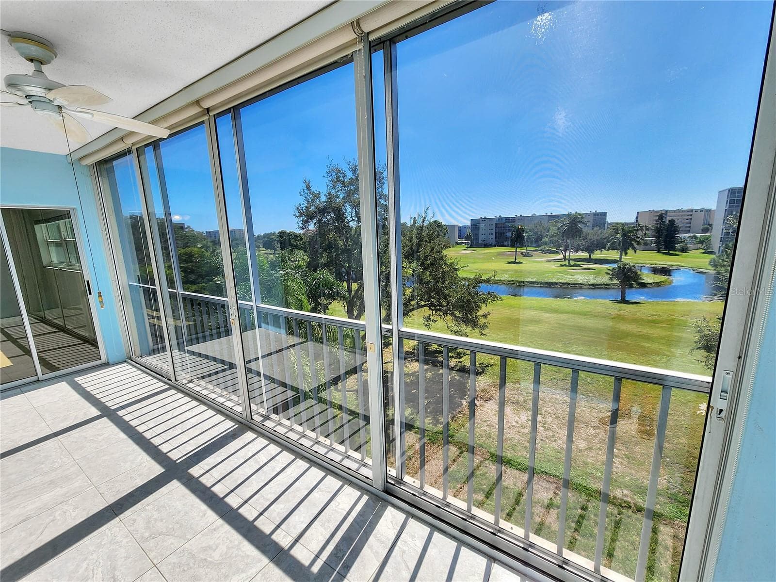 Balcony with golf course view. Door to primary bedroom - 3620 IRONWOOD CIR #404O, BRADENTON