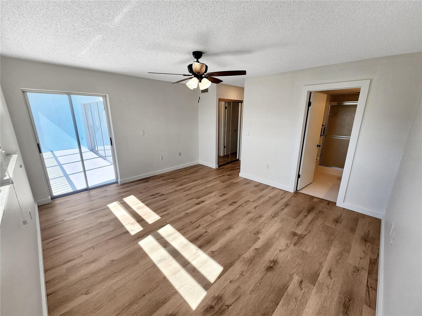Primary bedroom with door to balcony - 3620 IRONWOOD CIR #404O, BRADENTON