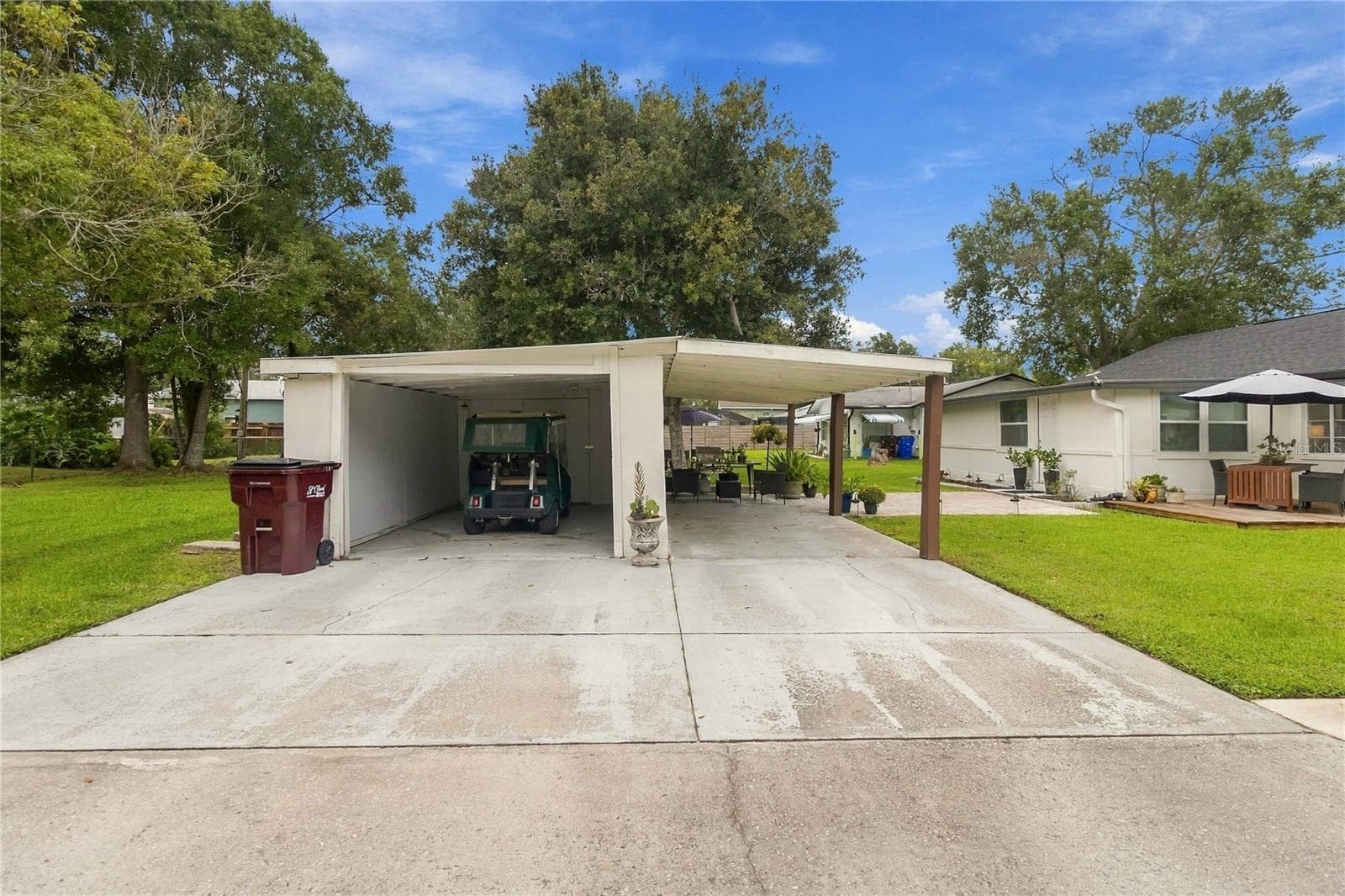 Detached garage with extra storage and a carport. - 438 VIRGINIA AVE, ST CLOUD
