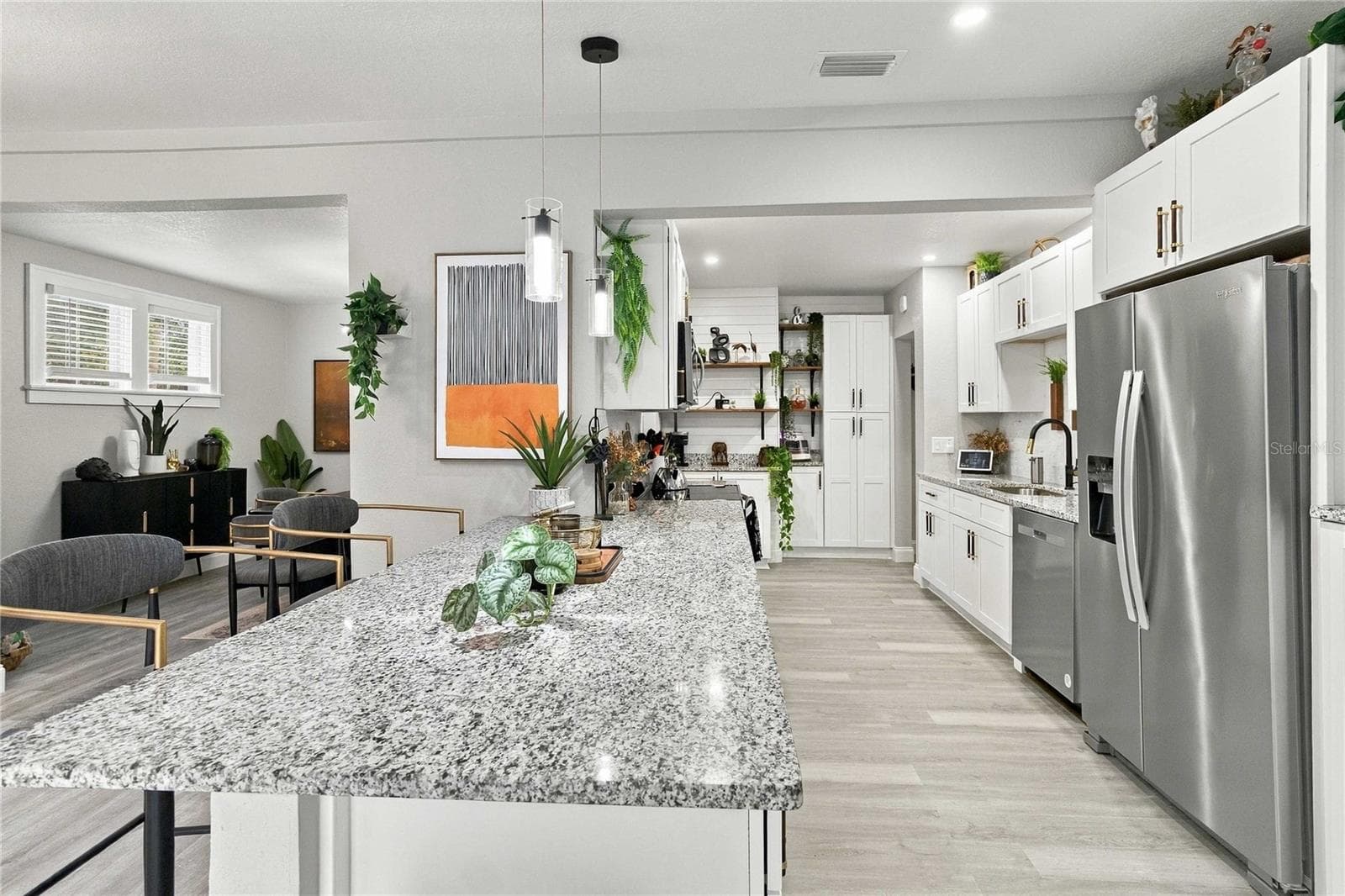 Kitchen with granite and stainless steel appliances. - 430 FLORIDA AVE, ST CLOUD