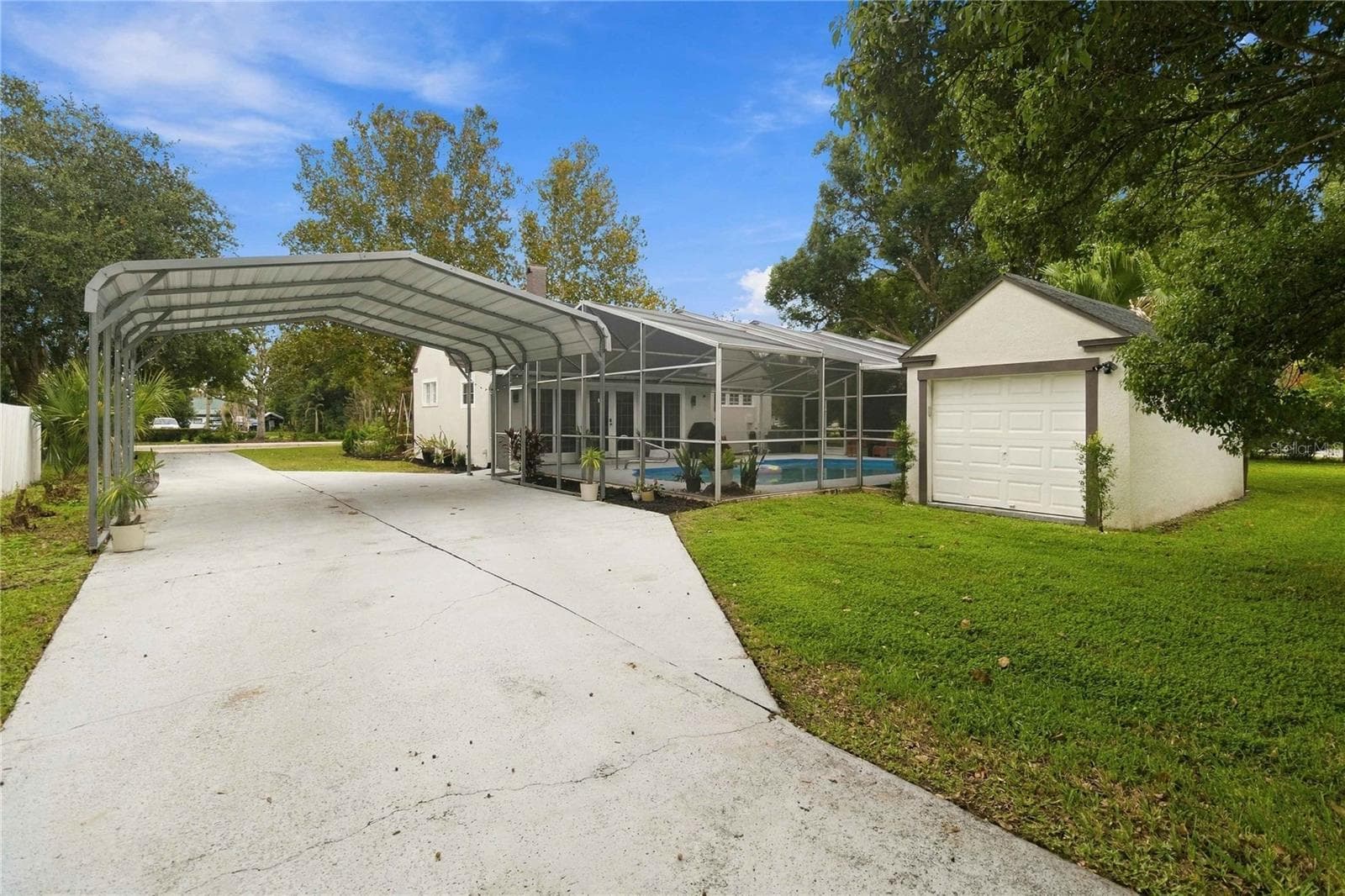 Detached garage and carport viewed from alley entrance to the home - 430 FLORIDA AVE, ST CLOUD
