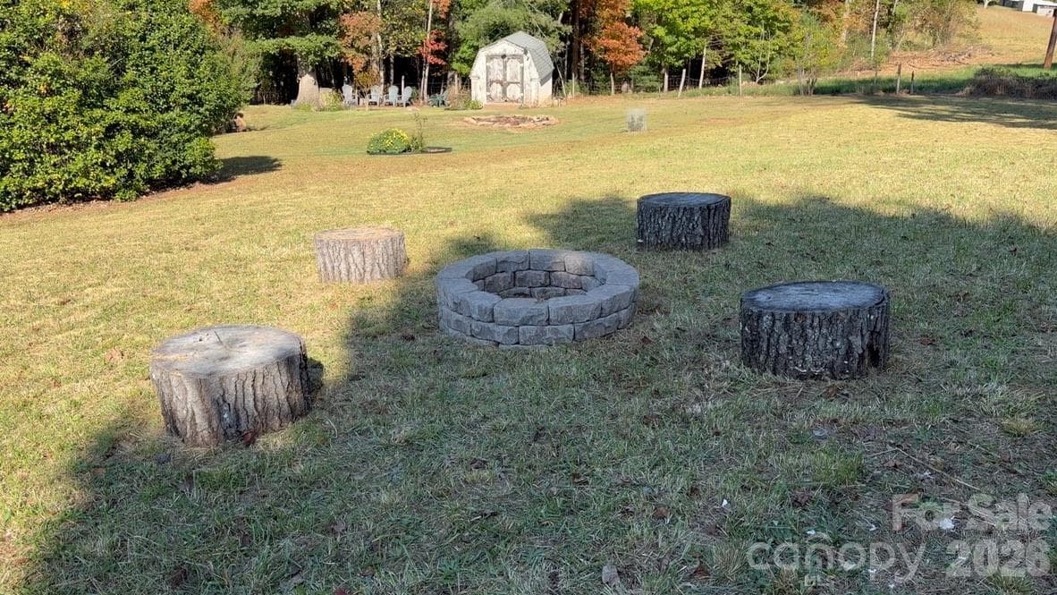 and the stone fire pit that invites social gatherings. - 202 Banyan Road, Candler