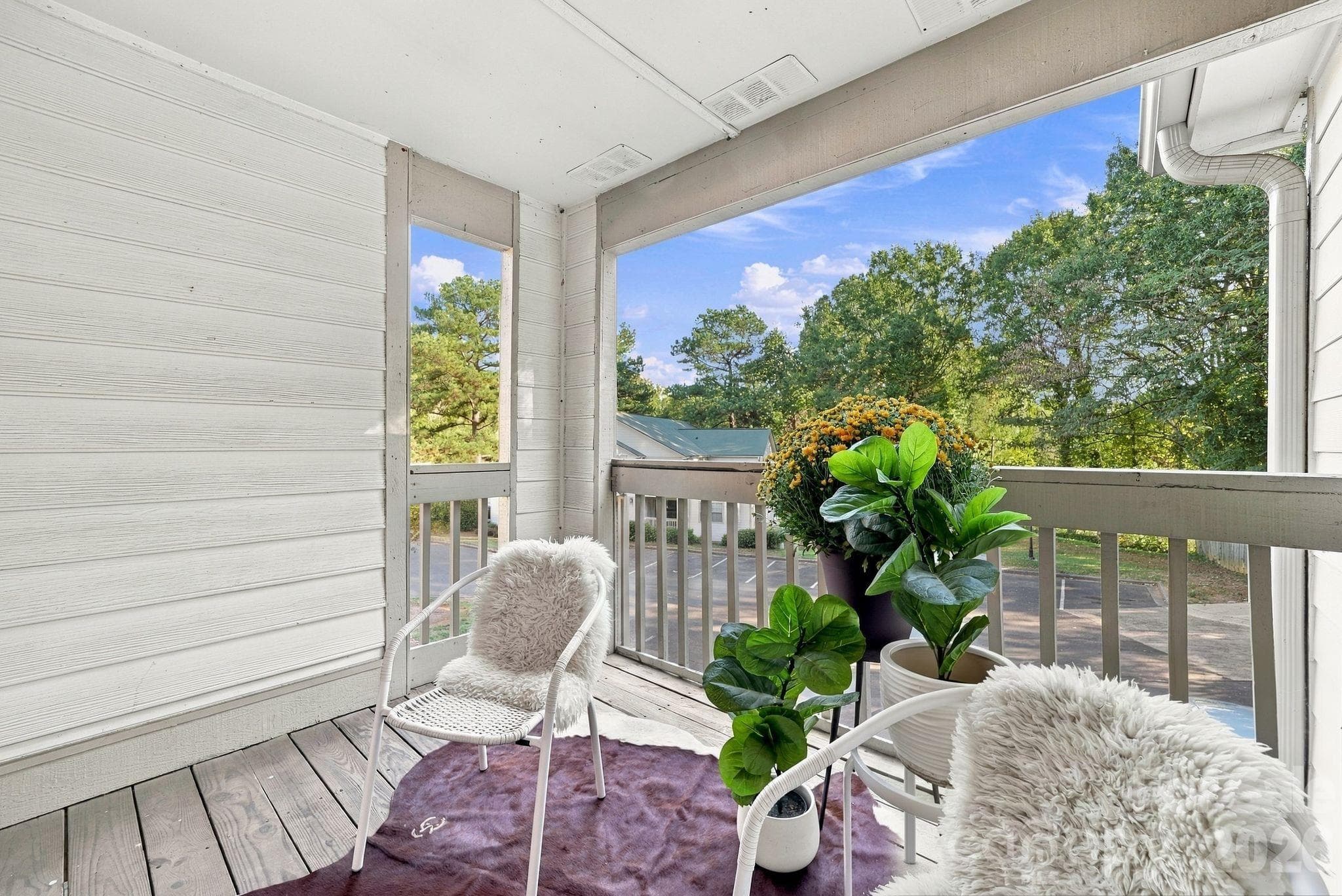 Covered balcony extends living area and includes a storage closet - 1051 Churchill Downs Court, Charlotte