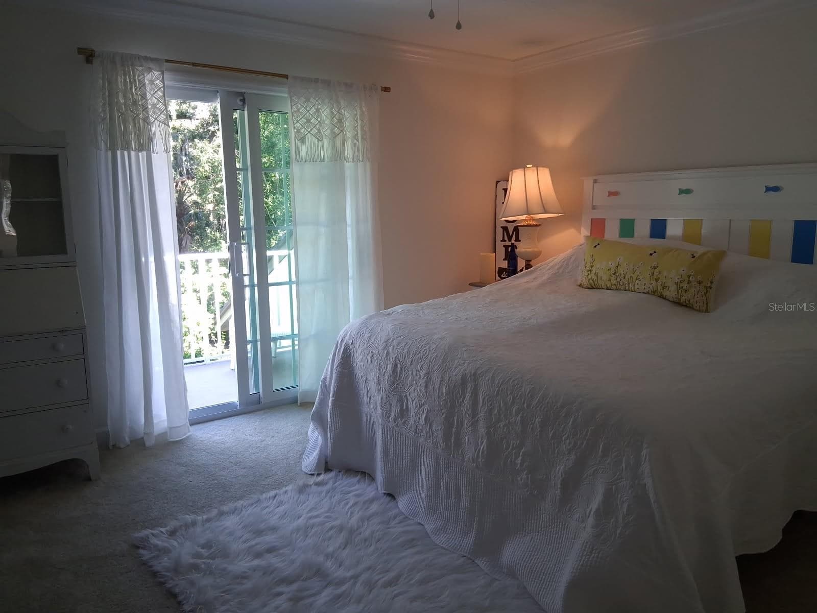 One of 2 additional bedrooms upstairs with New Impact Sliders and access to upstairs Balcony overlooks Formal Garden, rest of Yard and Golf Course - 3171 DICK WILSON DR, SARASOTA