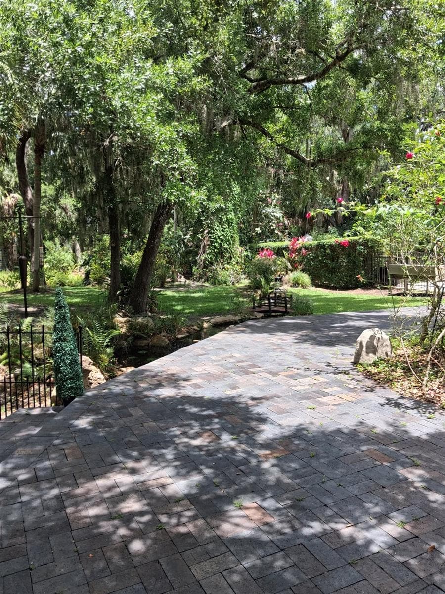 Real Clay Pavers , not the cheaper concrete dyed pavers were used here to build a stunning outdoor sitting area next to the Creek with Waterfalls. Perfect for  outdoor furniture with view of Golf Course in background - 3171 DICK WILSON DR, SARASOTA