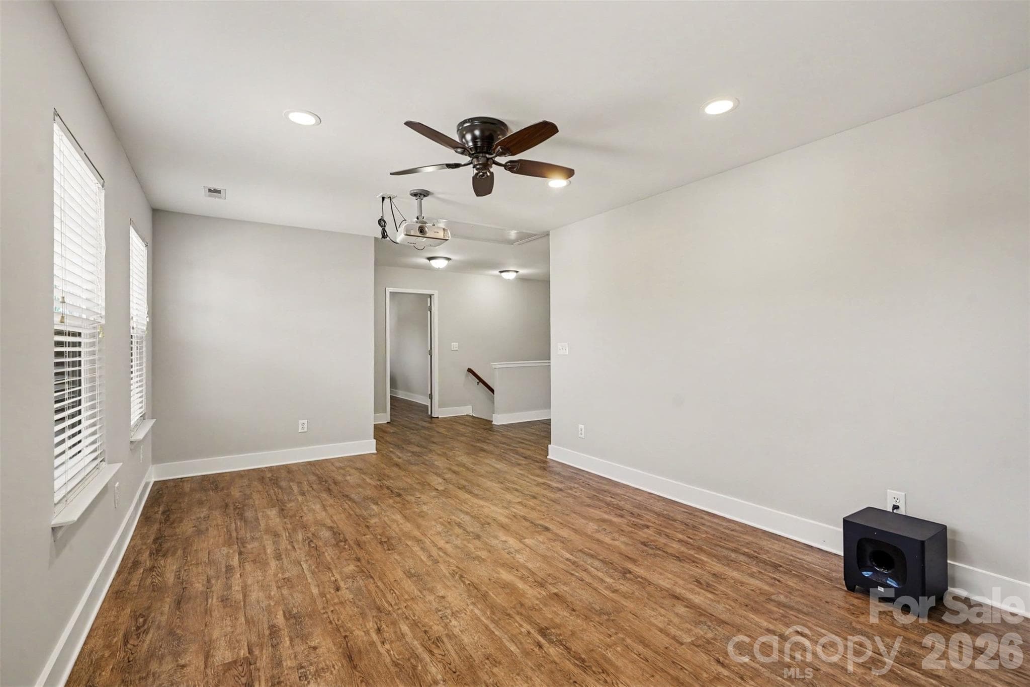 View of the Theater Room looking towards the stairs and one of the secondary bedrooms. - 3585 Leighton Drive SW, Concord