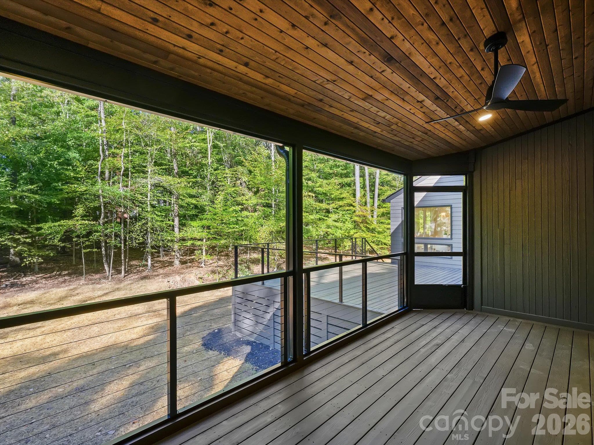 Screened porch overlooking wooded backyard - 5401 Lancelot Drive, Charlotte