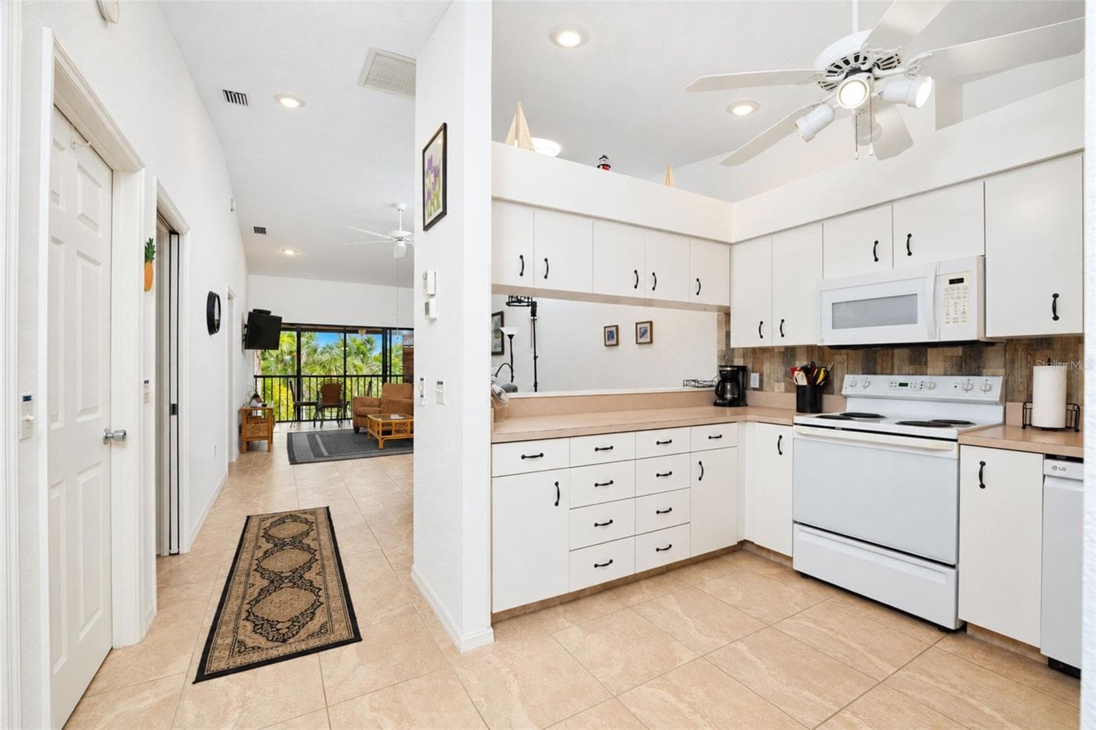 The kitchen offers abundant cabinetry and counter space. - 4260 PLACIDA RD #9C, ENGLEWOOD