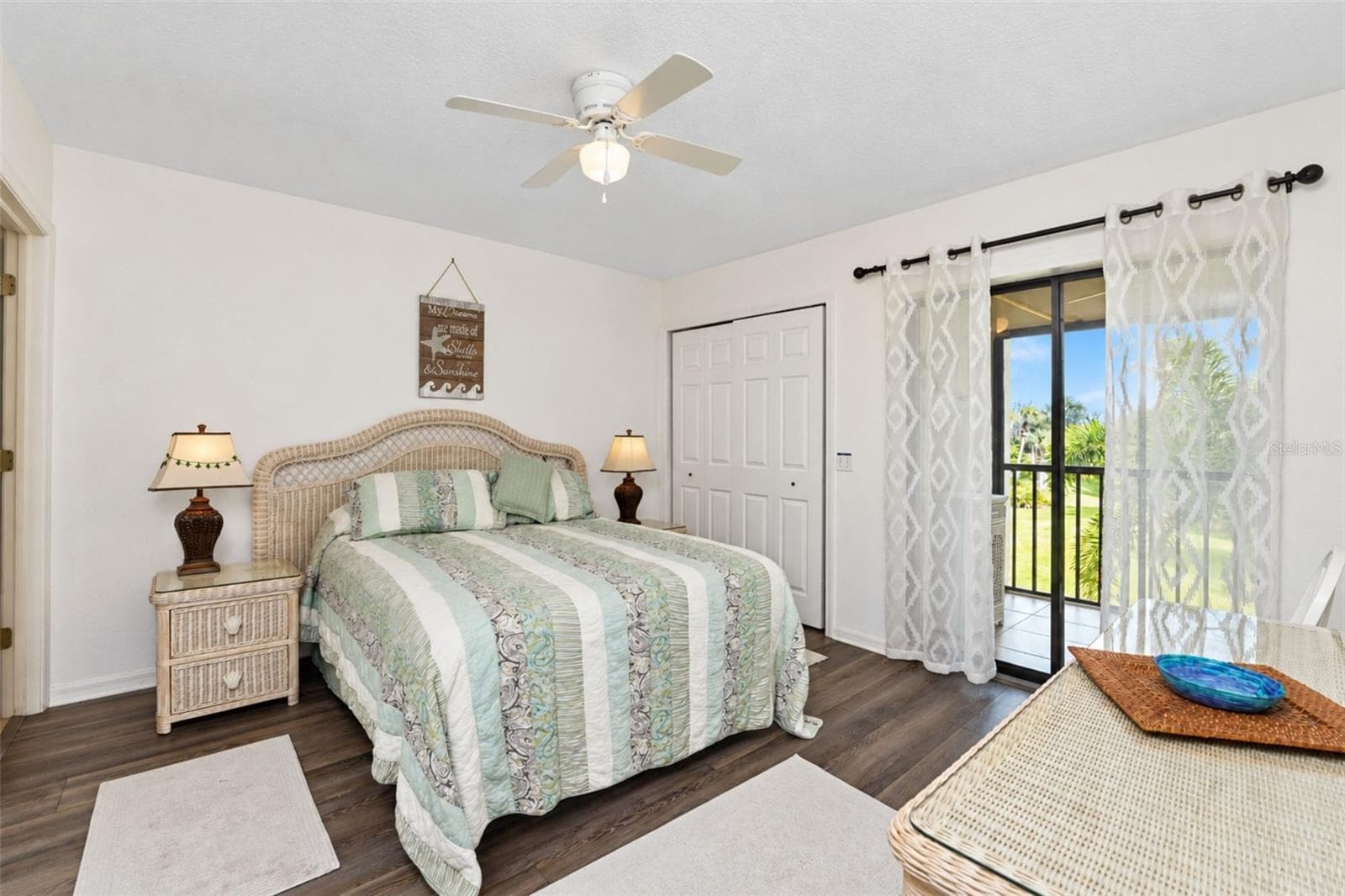 The primary bedroom has new laminate flooring, a ceiling fan, two wall closets and sliding glass doors to the lanai. - 4260 PLACIDA RD #9C, ENGLEWOOD
