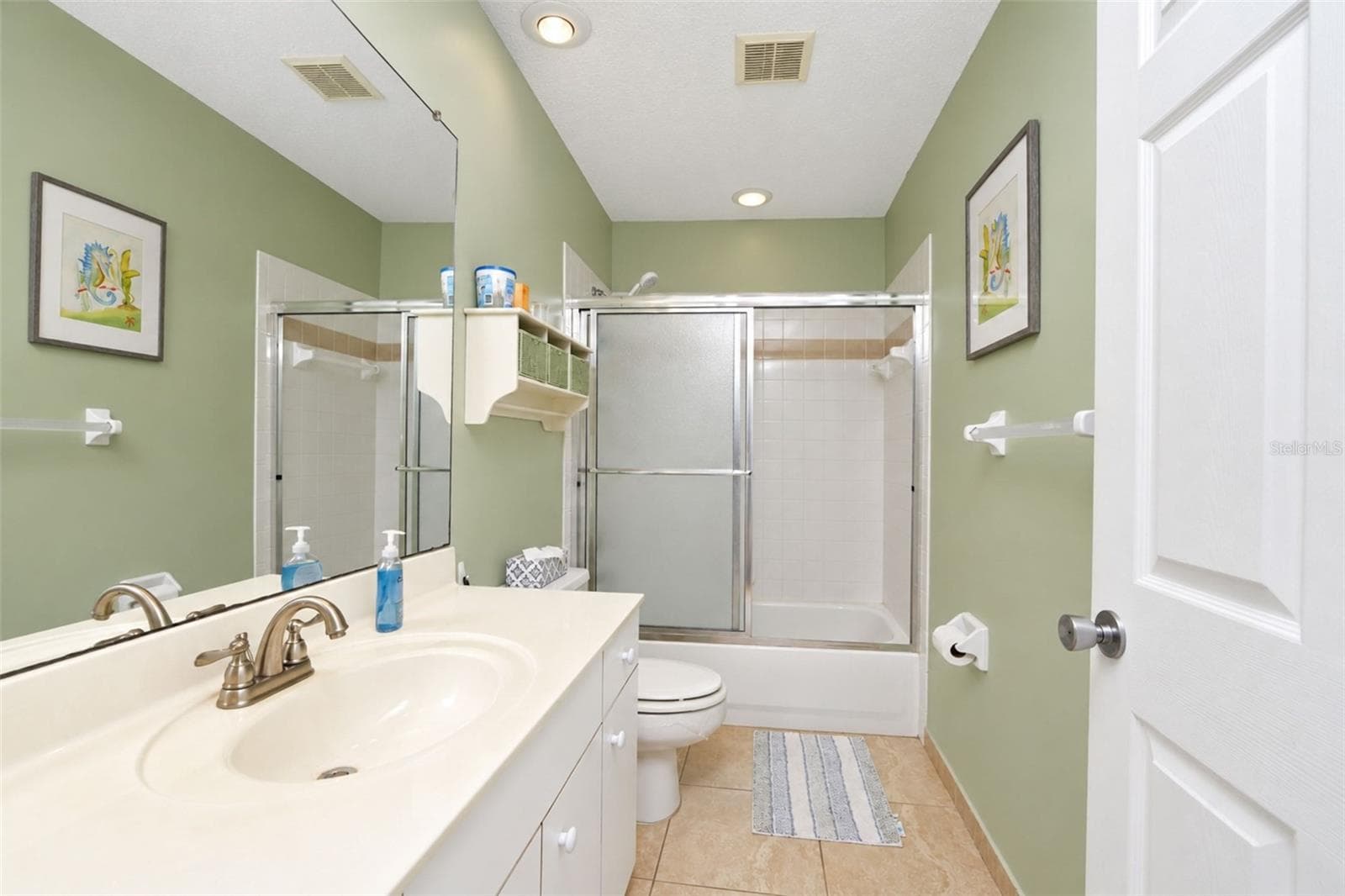 The ensuite bathroom features a tub/shower combo and tiled flooring. - 4260 PLACIDA RD #9C, ENGLEWOOD