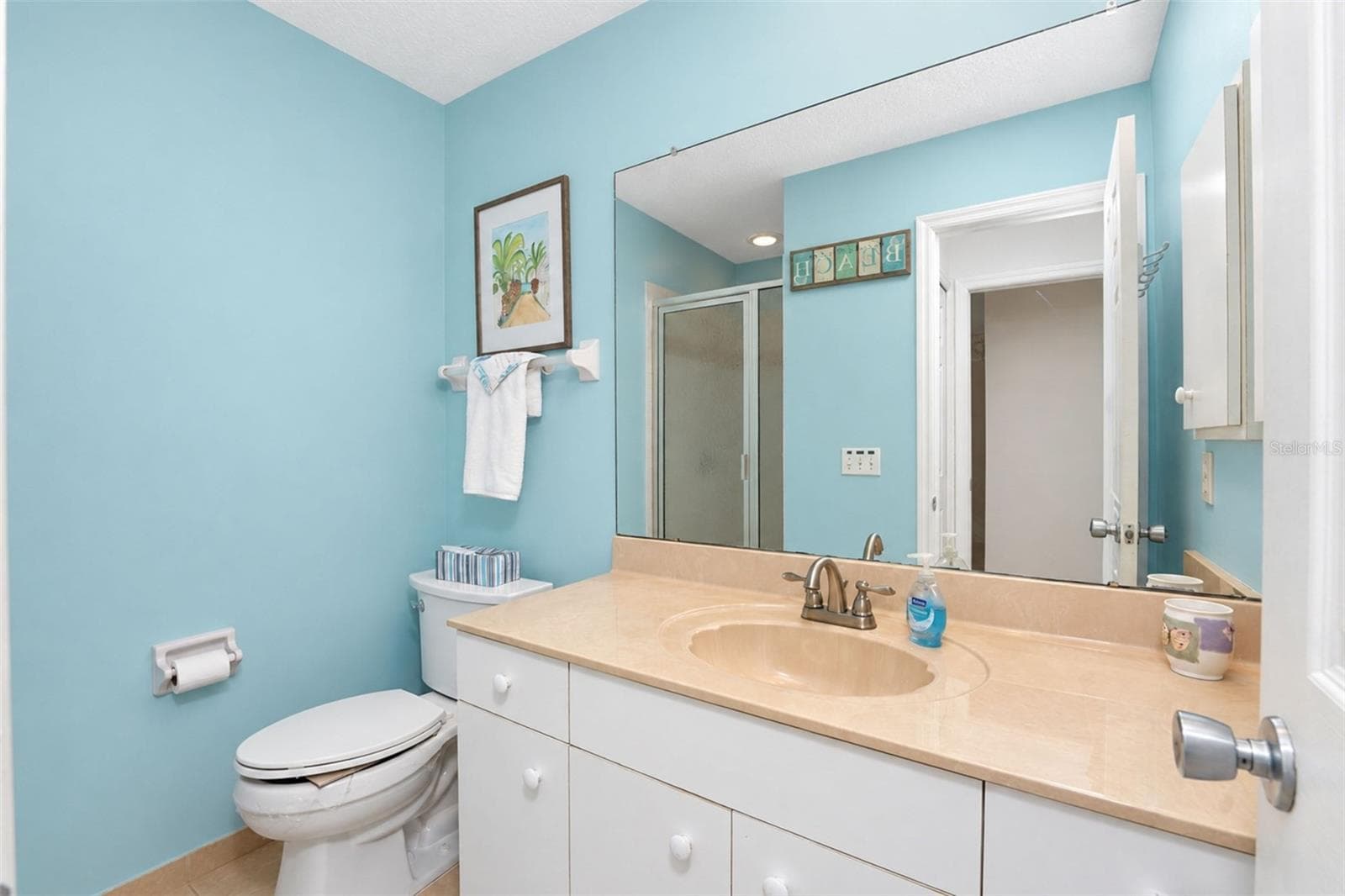 The guest bathroom has a step-in shower and tiled flooring. - 4260 PLACIDA RD #9C, ENGLEWOOD