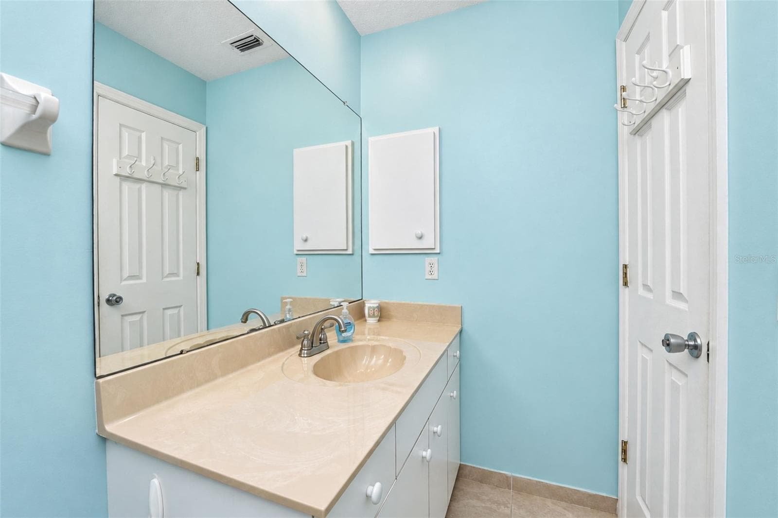 The guest bathroom vanity has a cultured marble countertop. - 4260 PLACIDA RD #9C, ENGLEWOOD