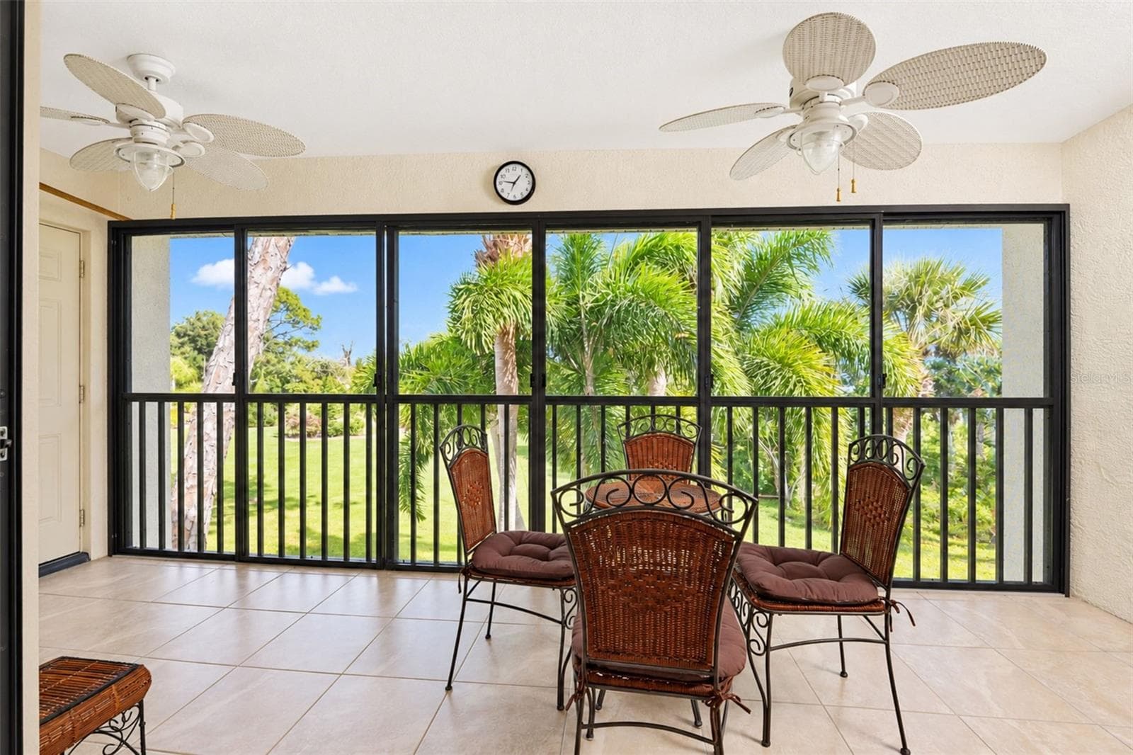 The vinyl enclosed lanai has tiled flooring and 2 ceiling fans. - 4260 PLACIDA RD #9C, ENGLEWOOD