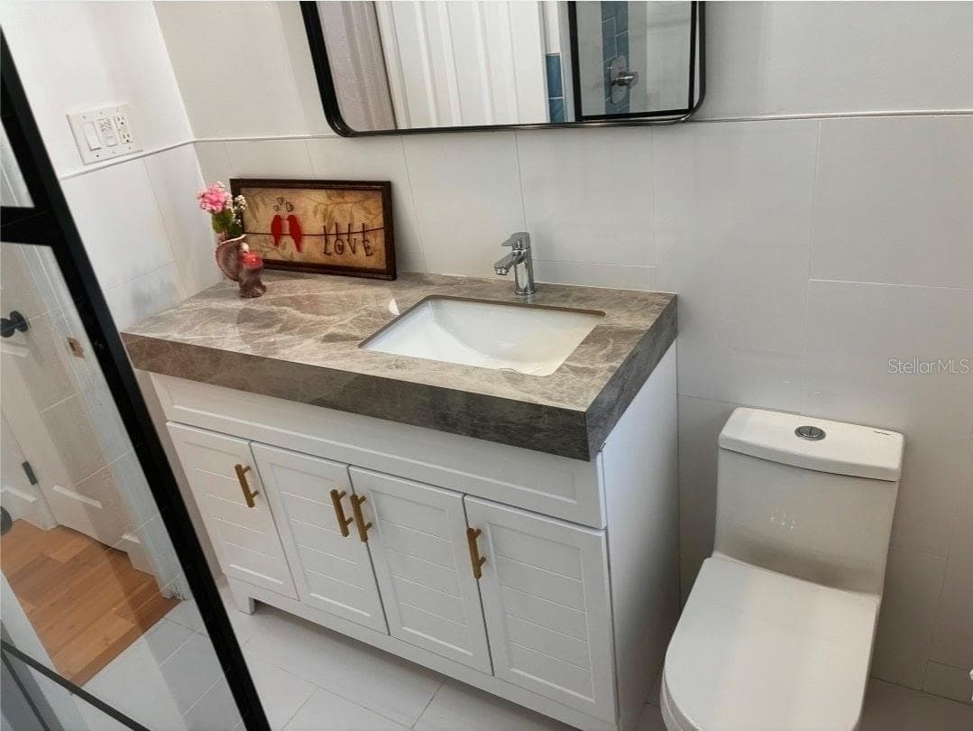 Beautiful new full bath with a walk in Tile shower - 8175 GULF BLVD, ST PETE BEACH