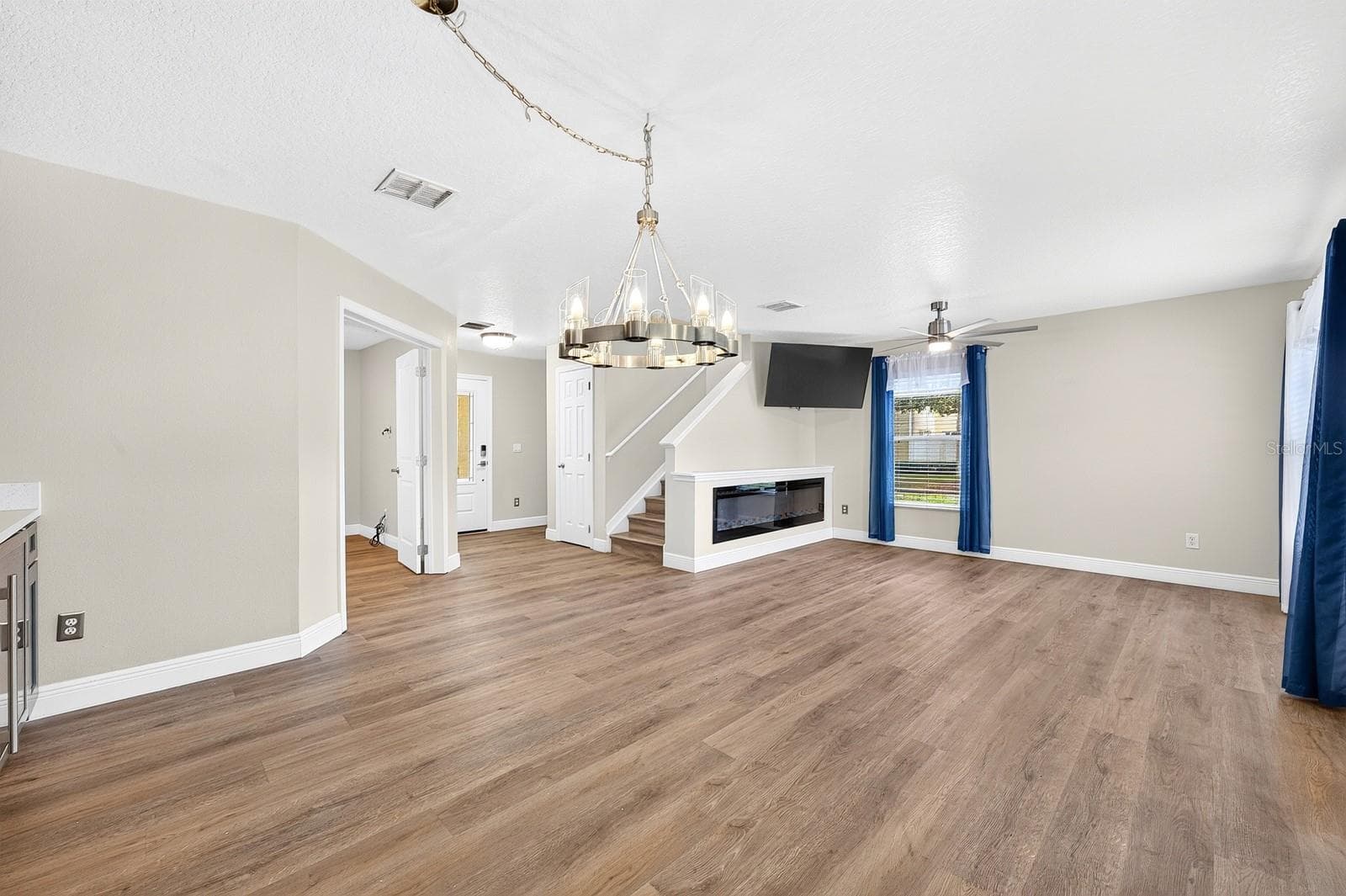 The living and dining space opens to both the updated modern kitchen, flex room, and fenced patio space. - 13028 AUBURN COVE LN, ORLANDO