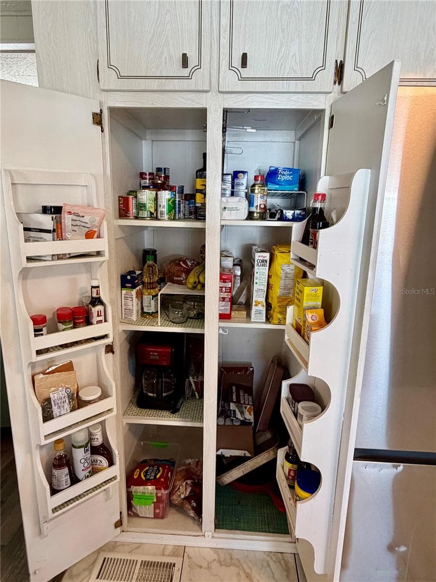 Pantry next to the refrigerator - 34085 ALAMANDA DR N, PINELLAS PARK