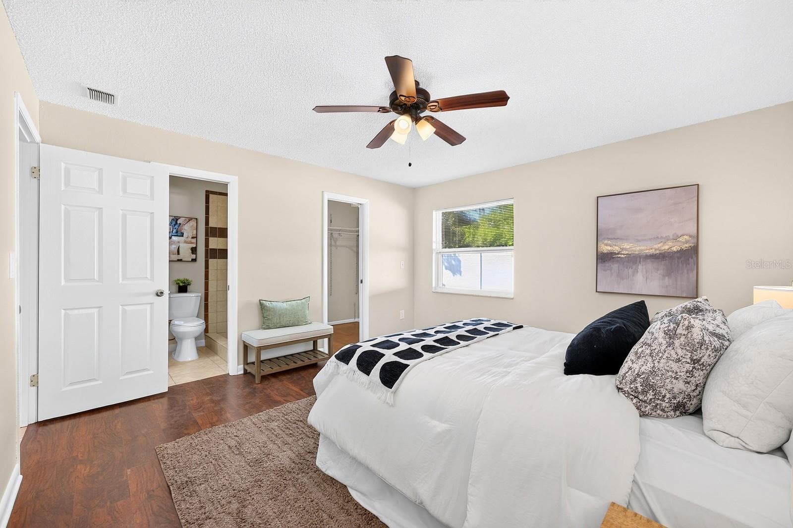 The Primary Suite offers laminate flooring, a WALK-IN CLOSET and private en suite Bath. - 543 HIBISCUS WAY #9C, ORLANDO