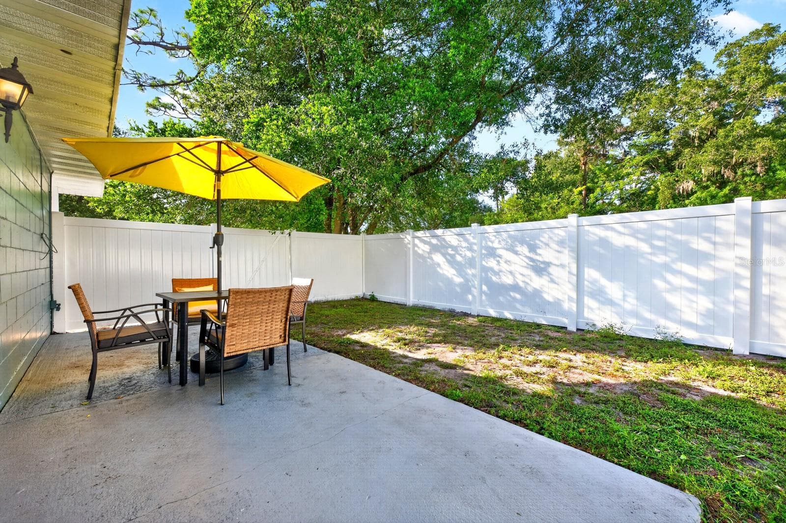 Sliding glass doors open to a SIDE PATIO, offering a lovely spot to enjoy your morning coffee or relax outdoors. - 543 HIBISCUS WAY #9C, ORLANDO