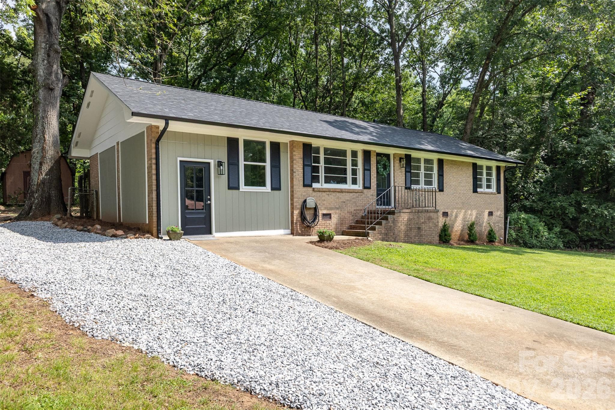 Angled front showing driveway and gravel parking - 1948 Marett Boulevard, Rock Hill
