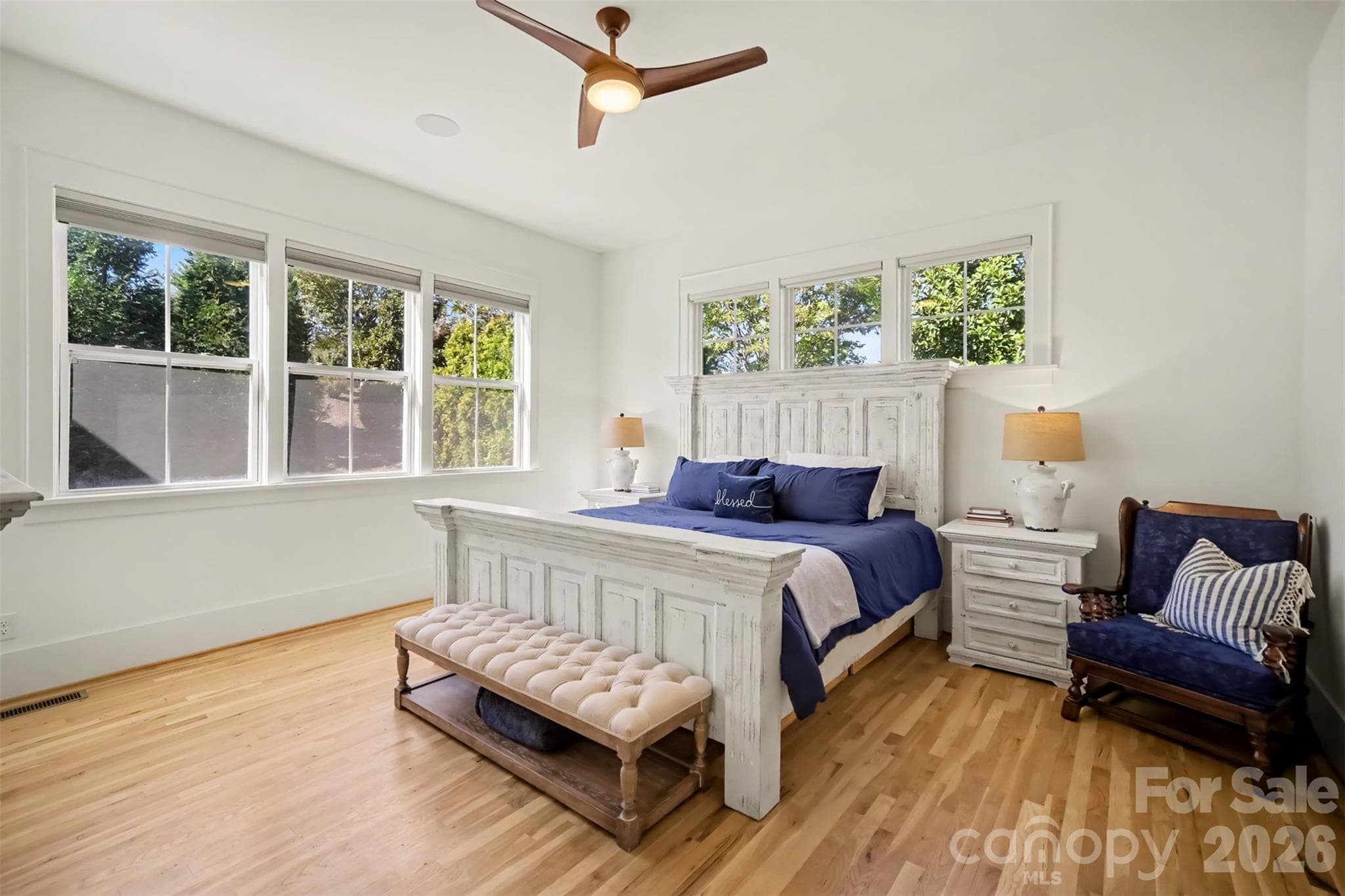 Spacious Primary Suite on Main level with lots of windows and hardwood floors - 206 June Bug Lane, Fort Mill