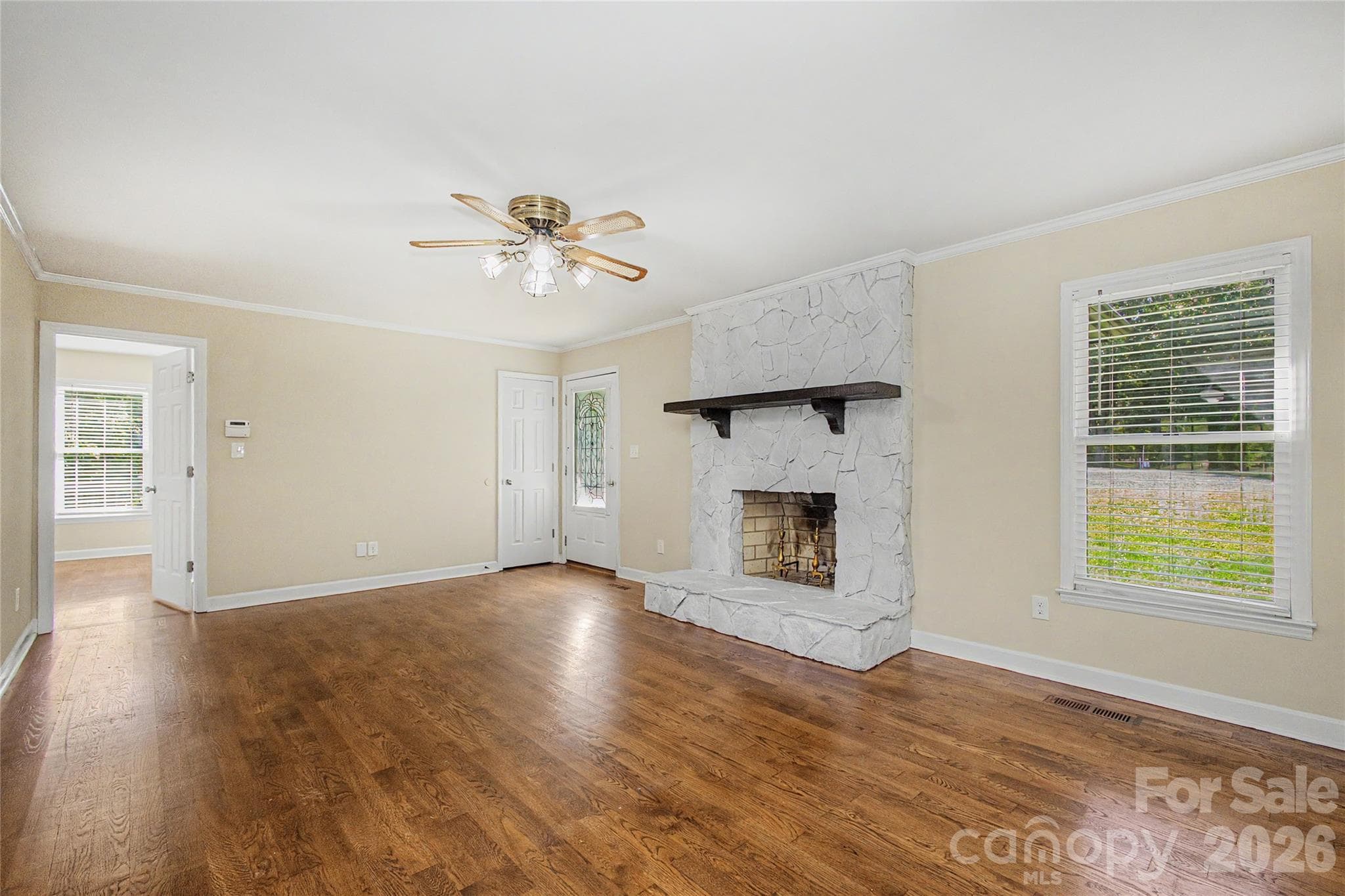 The Living Room is the first  room as you enter the home.  Features are hardwood flooring and wood burning fireplace with mantle - 3121 Lakeside Circle, Belmont