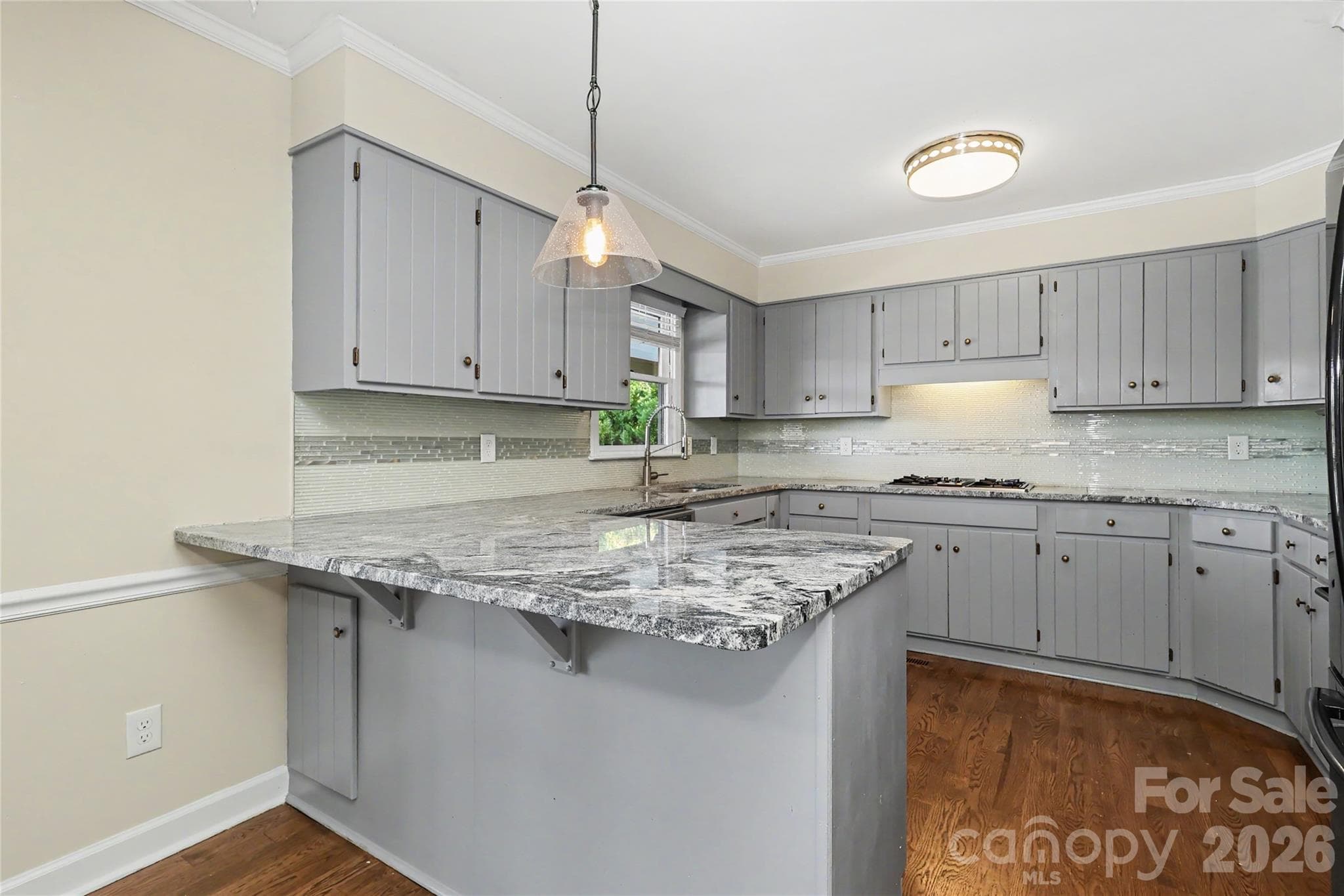 Granite Counters, pendant light, double sink with disposal, dishwasher, gas cooktop, double ovens and refrigerator - 3121 Lakeside Circle, Belmont