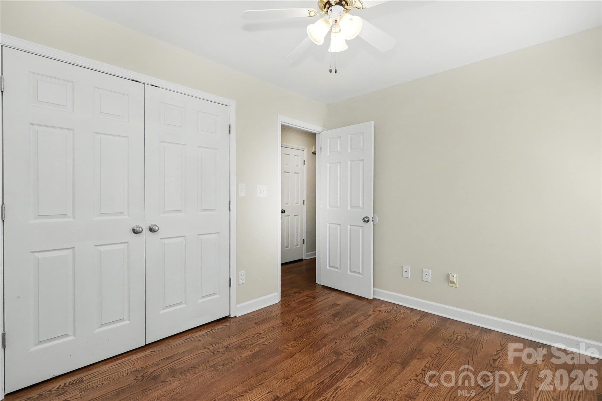 Bedroom 2 in front of home with large closet and hardwoods - 3121 Lakeside Circle, Belmont