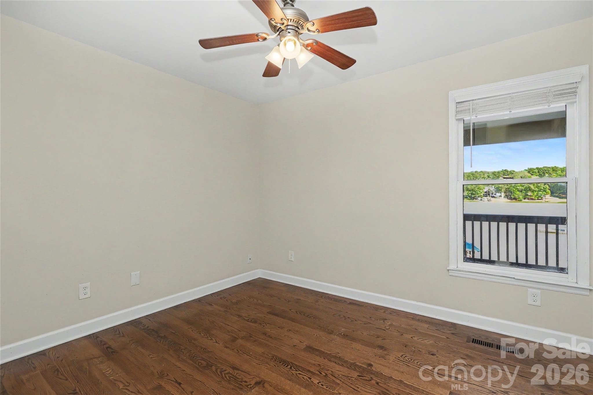 Bedroom 3 with large closet and hardwoods, window showing the water in the background - 3121 Lakeside Circle, Belmont