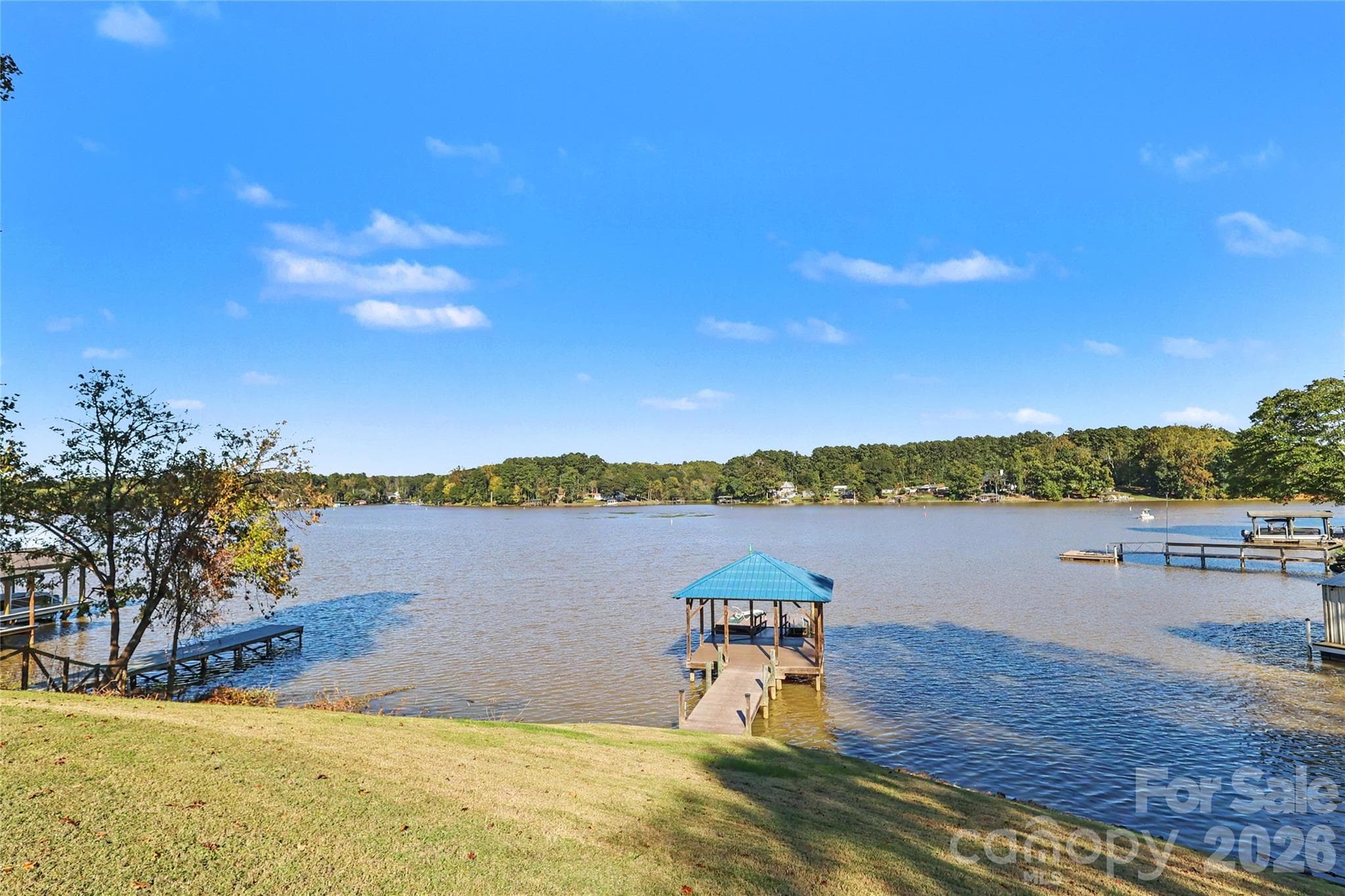 Beautiful backyard with long range view of the lake, covered area over the water and a floating pier. - 3121 Lakeside Circle, Belmont