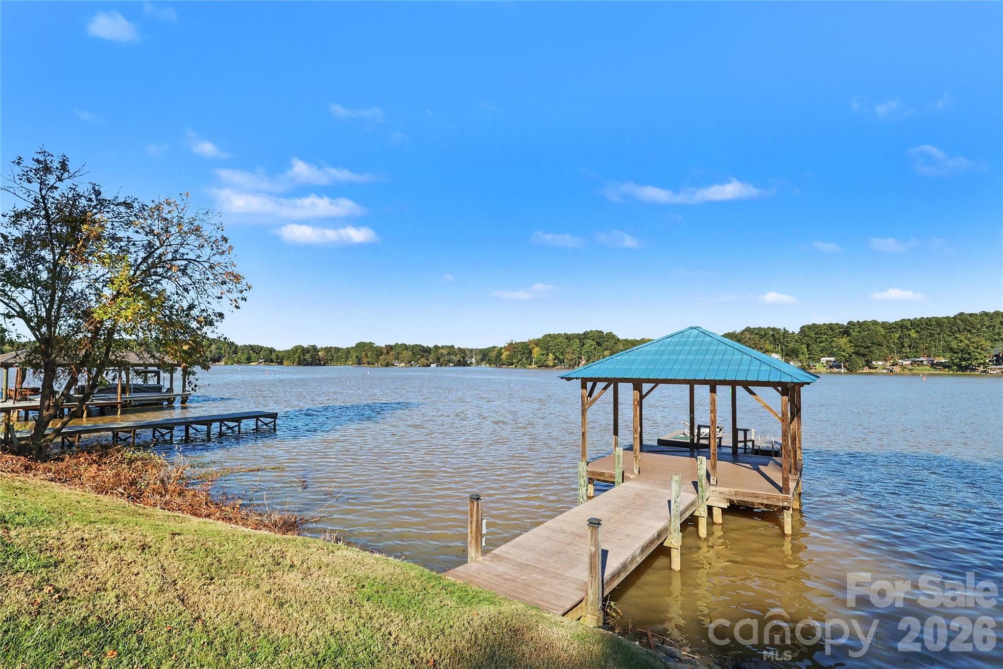 Long range view of the lake, covered area over the water and a floating pier. - 3121 Lakeside Circle, Belmont