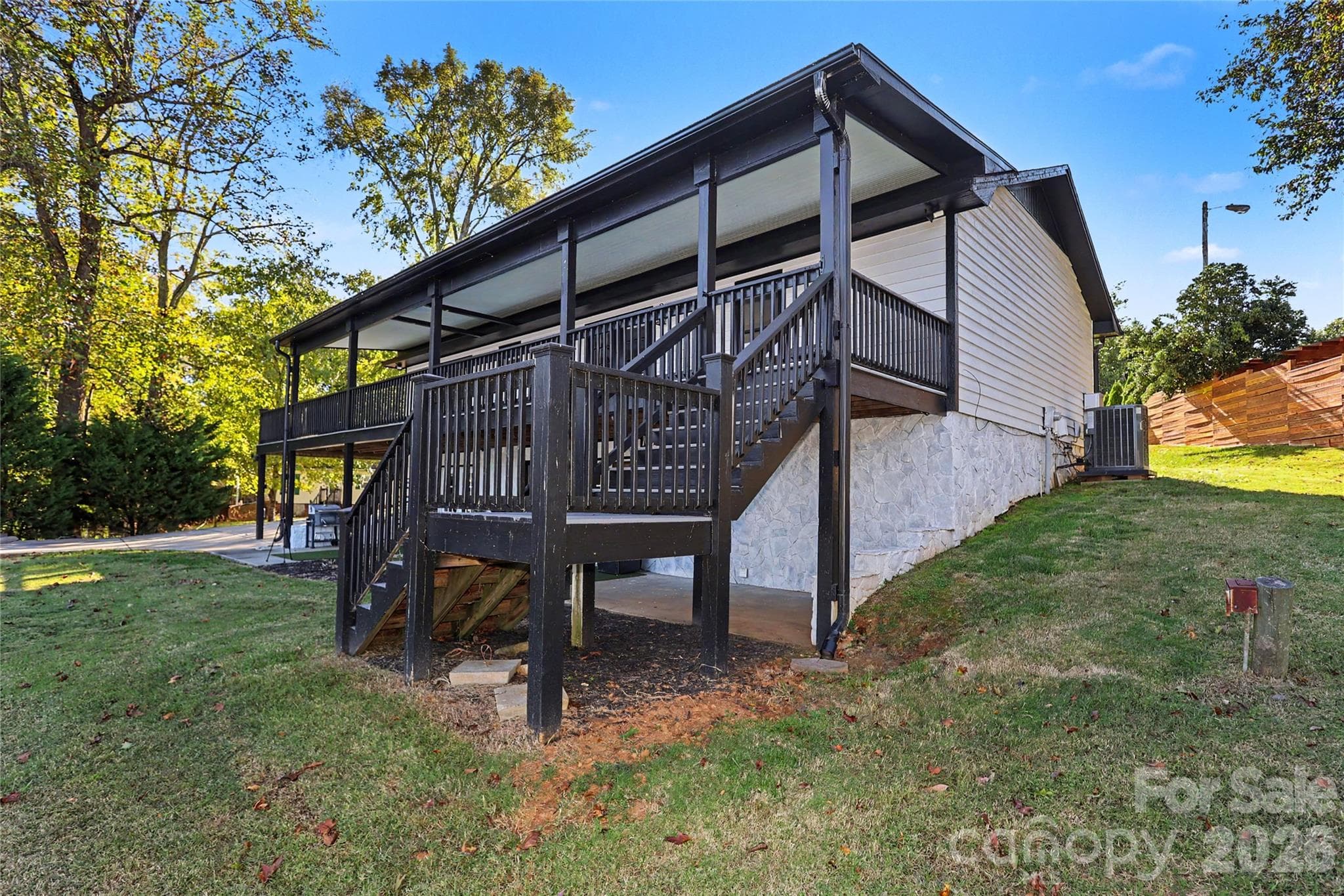 Back view of the home with stairs leading to the main level porch - 3121 Lakeside Circle, Belmont