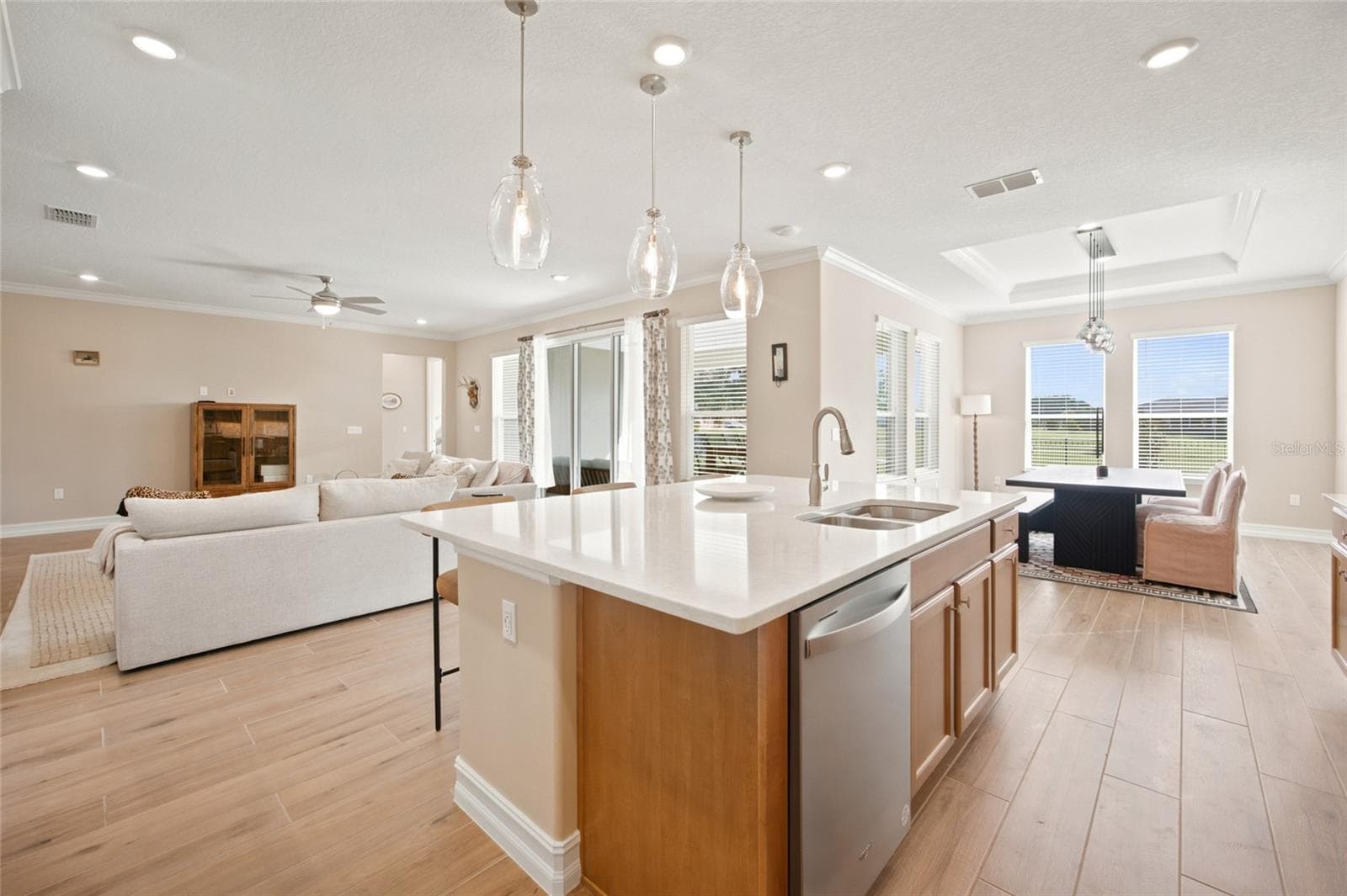 Open-concept design connecting the kitchen, living room and light-filled dining area. - 4497 NW 54TH TER, OCALA