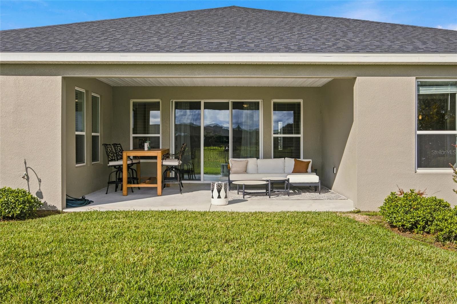 Spacious covered patio with room for outdoor dining and relaxation. - 4497 NW 54TH TER, OCALA