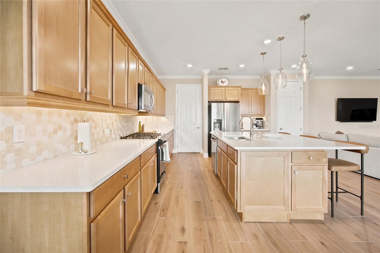 Long kitchen counter and cabinet layout providing abundant preparation and storage space. - 4497 NW 54TH TER, OCALA