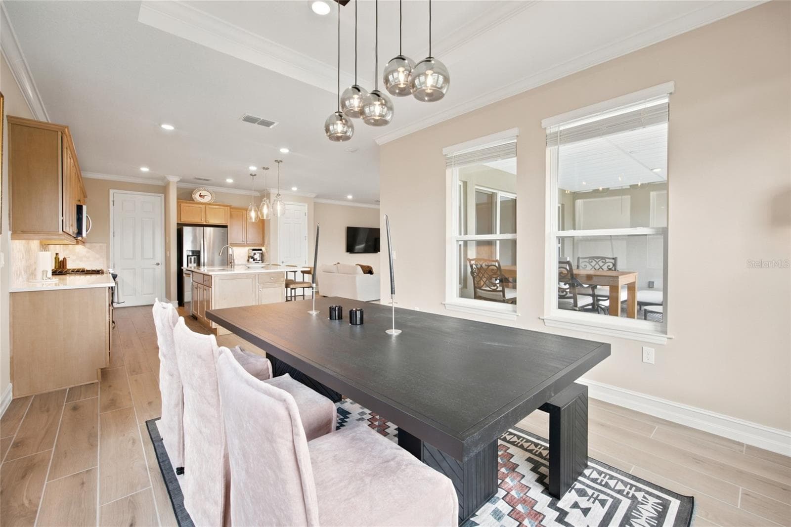 Dining area with decorative lighting and an open connection to the kitchen. - 4497 NW 54TH TER, OCALA