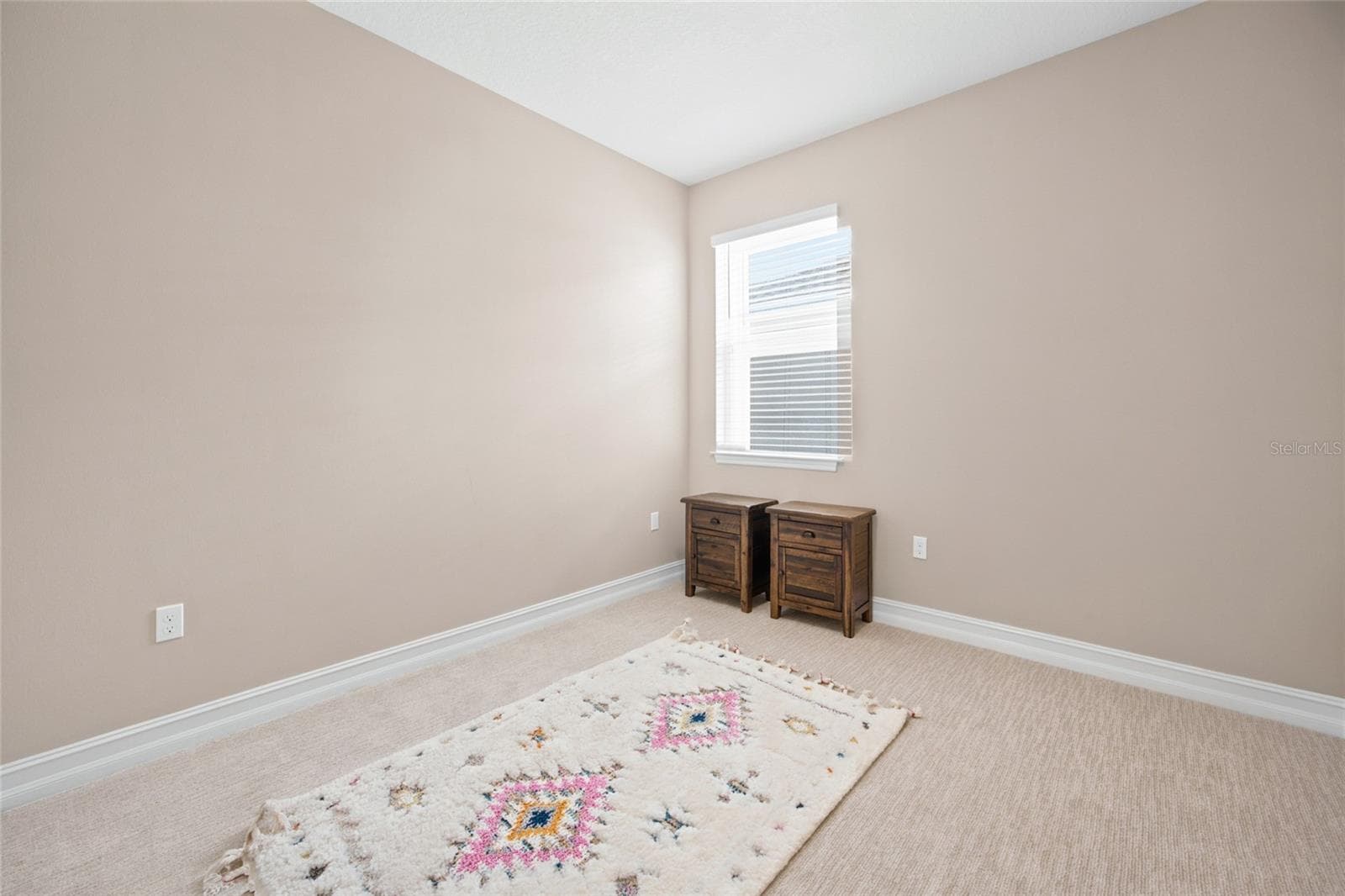 Secondary bedroom with neutral finishes and natural light. - 4497 NW 54TH TER, OCALA