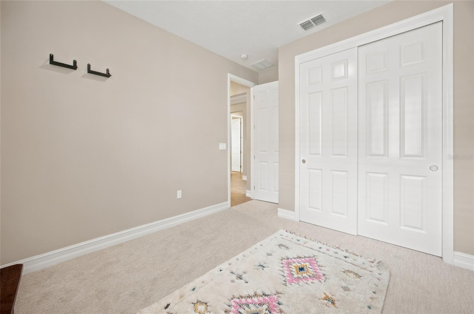 Additional view of the secondary bedroom showing its double-door closet. - 4497 NW 54TH TER, OCALA