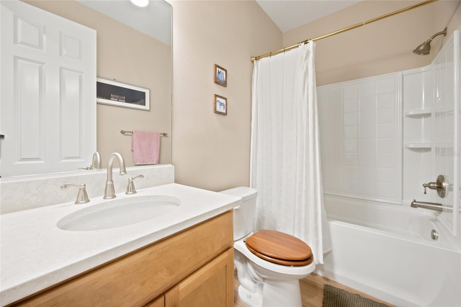 Full guest bathroom with vanity and tub/shower combination. - 4497 NW 54TH TER, OCALA