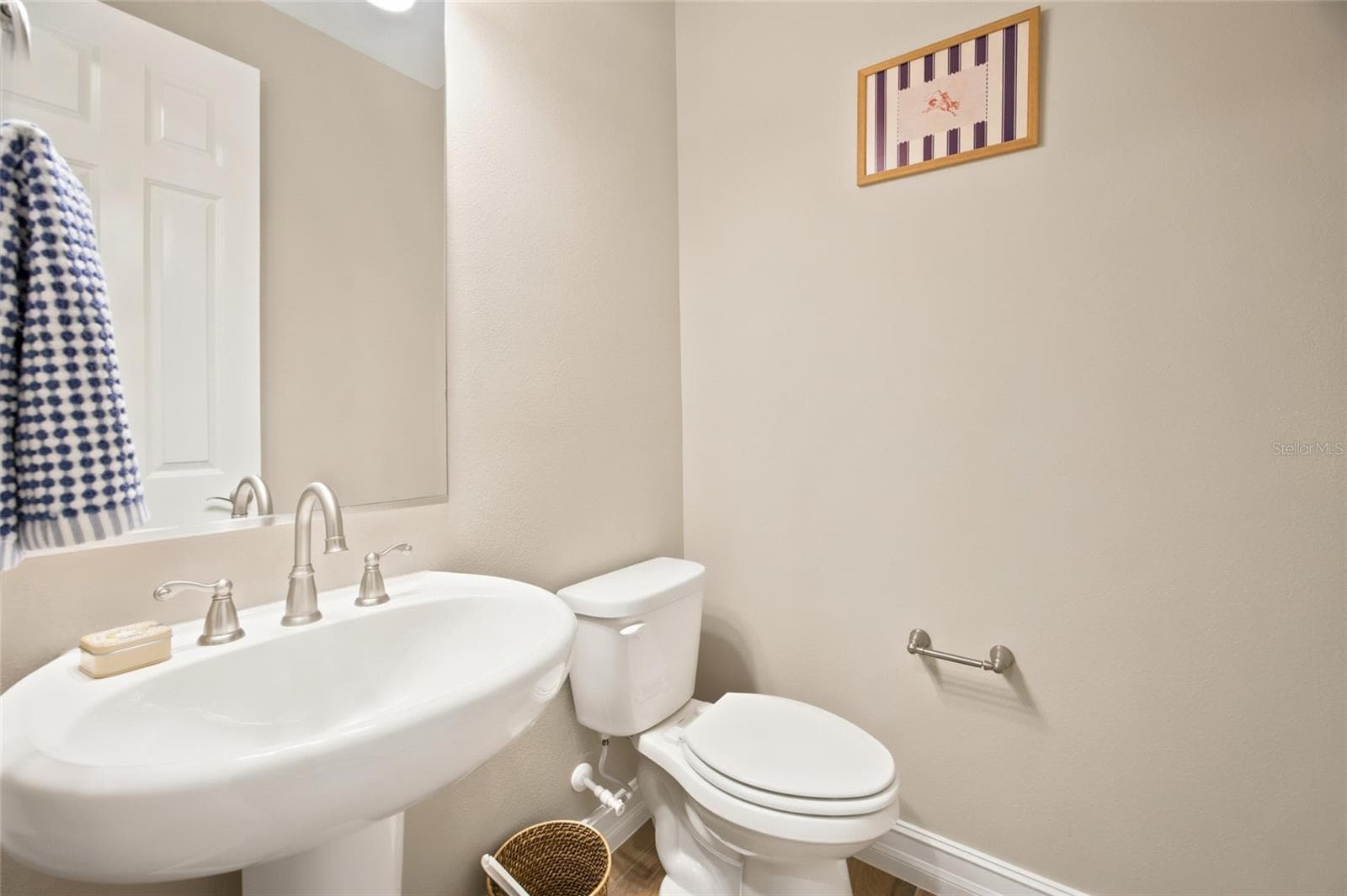 Convenient half bathroom with pedestal sink. - 4497 NW 54TH TER, OCALA