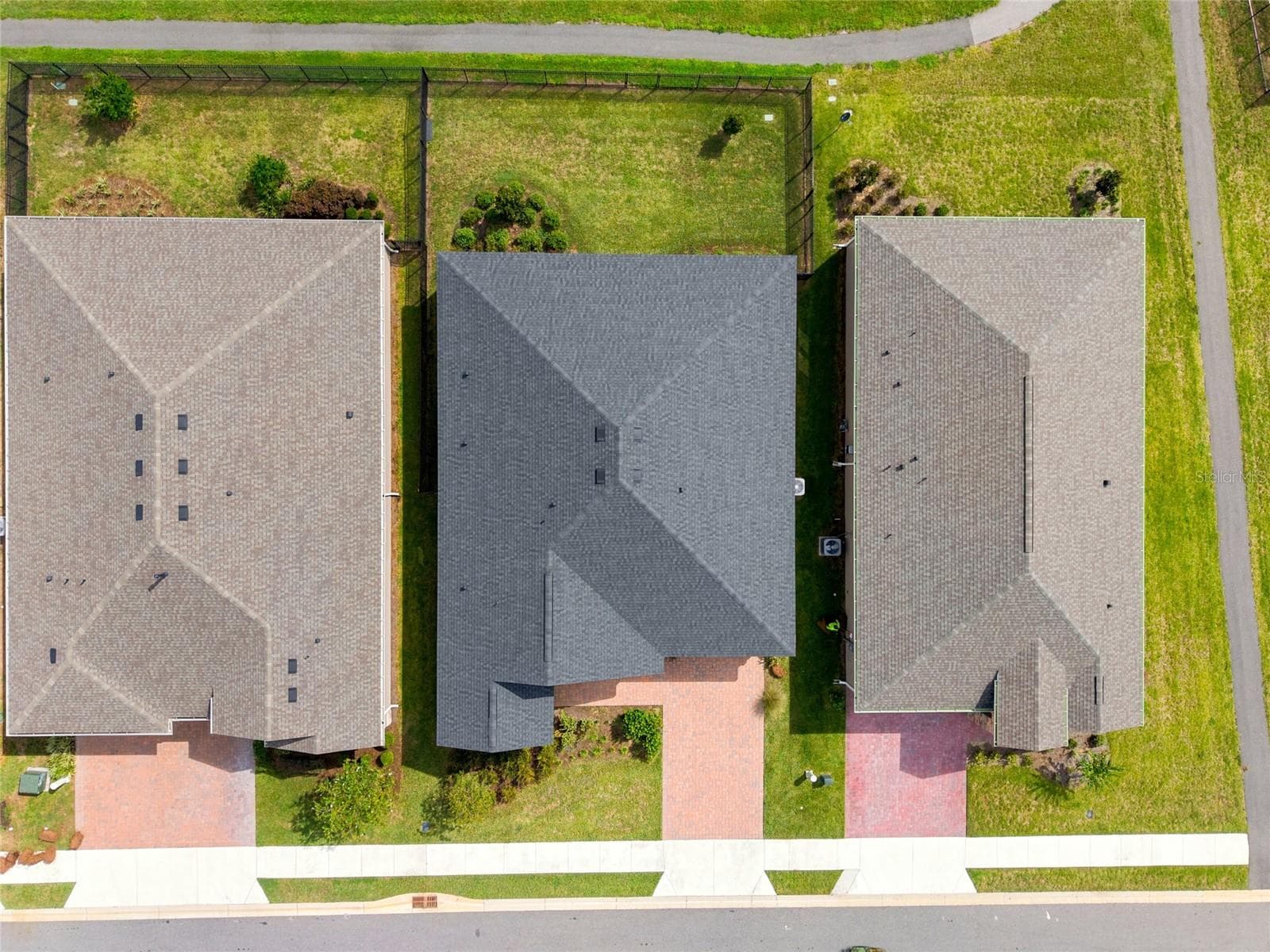 Overhead aerial showing the home's roofline, driveway and fenced backyard. - 4497 NW 54TH TER, OCALA