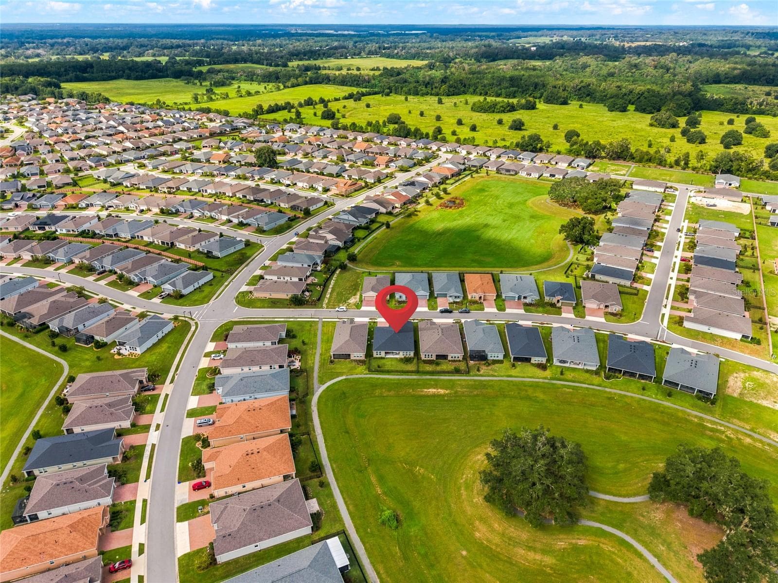 Wider aerial view identifying the home within the surrounding residential community. - 4497 NW 54TH TER, OCALA