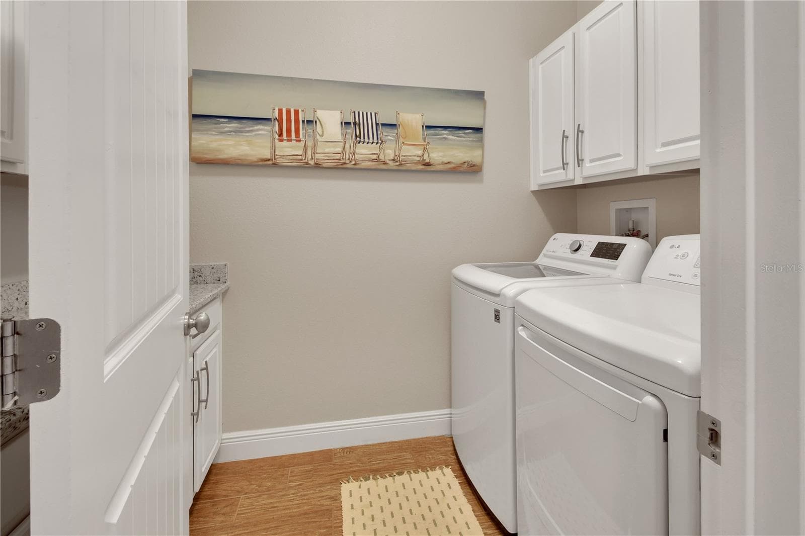 Laundry room with tons of cabinets and folding counter - 126 MYRTLEBERRY LN, DELAND