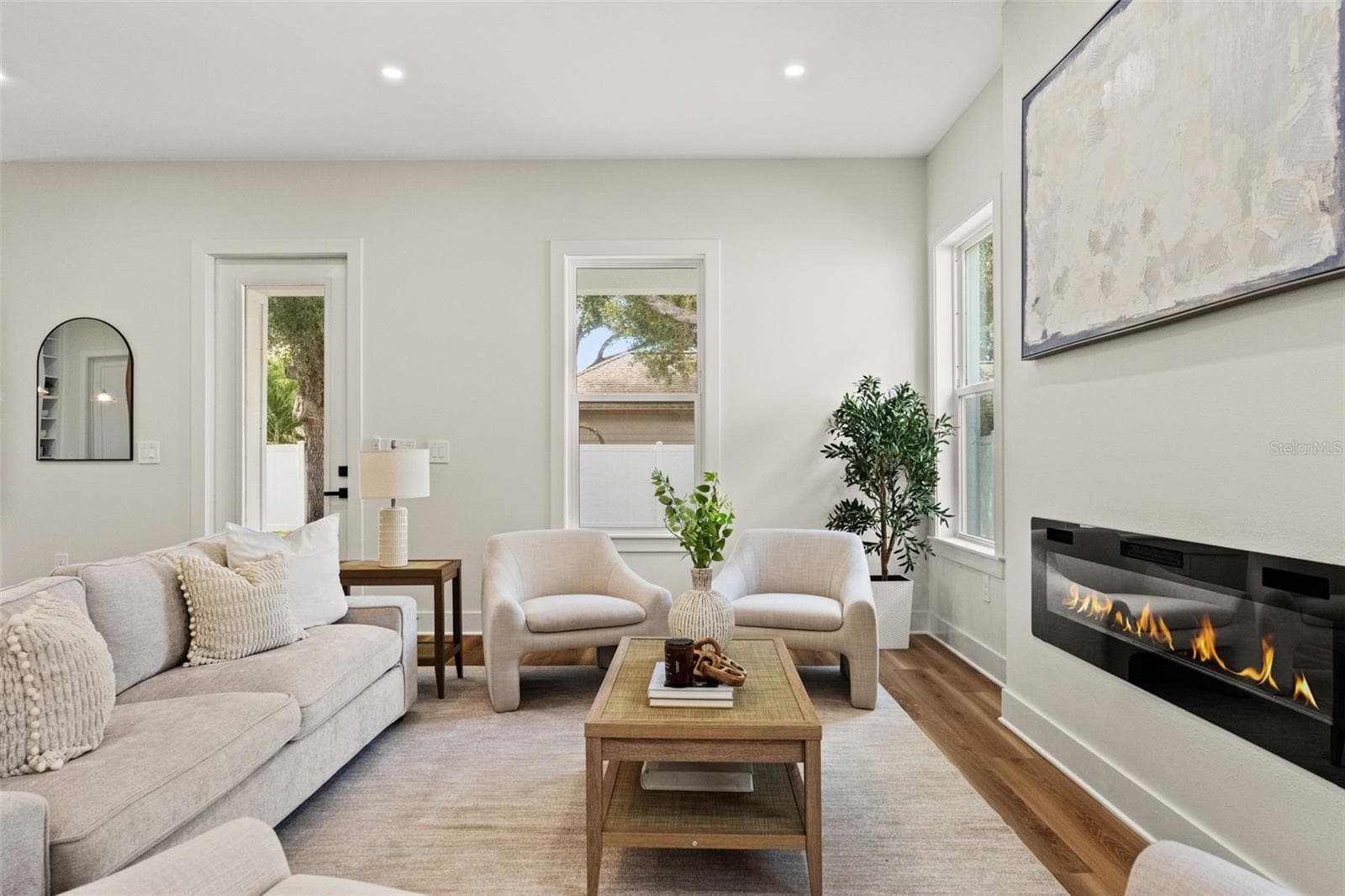 Living room with quartz fireplace - 10144 HODSON PL, SEMINOLE