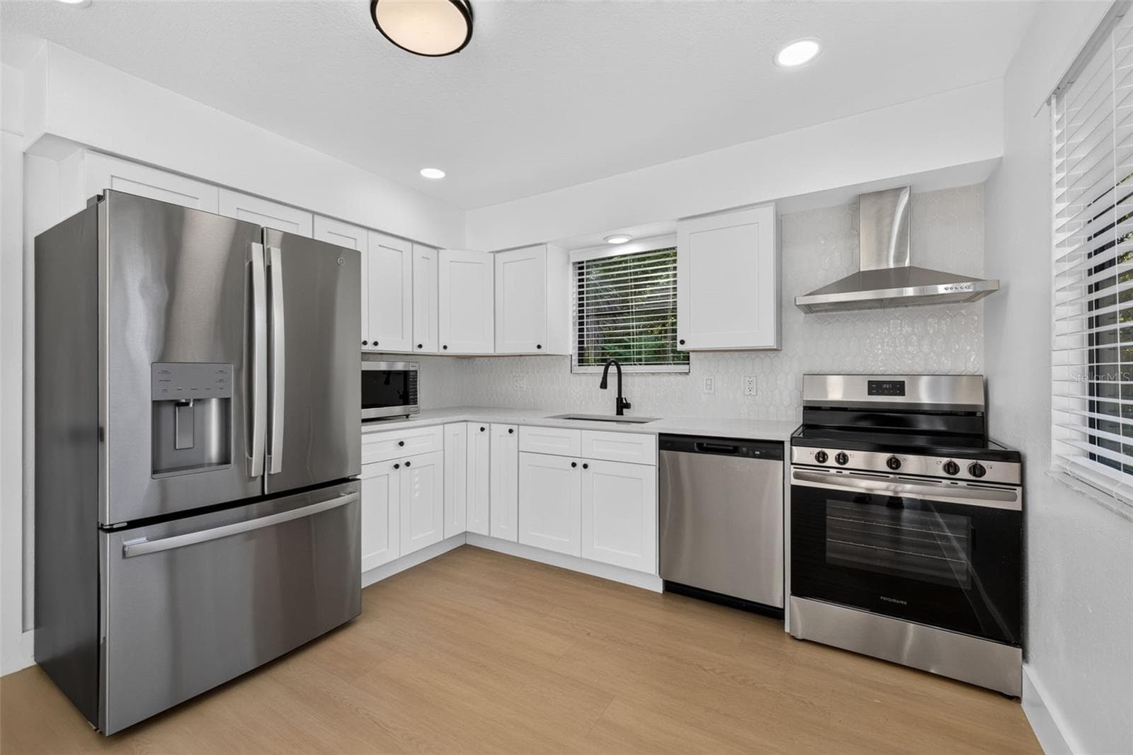 Updated kitchen featuring quartz countertops and stainless steel appliances. - 16107 SEA PINES DR, HUDSON