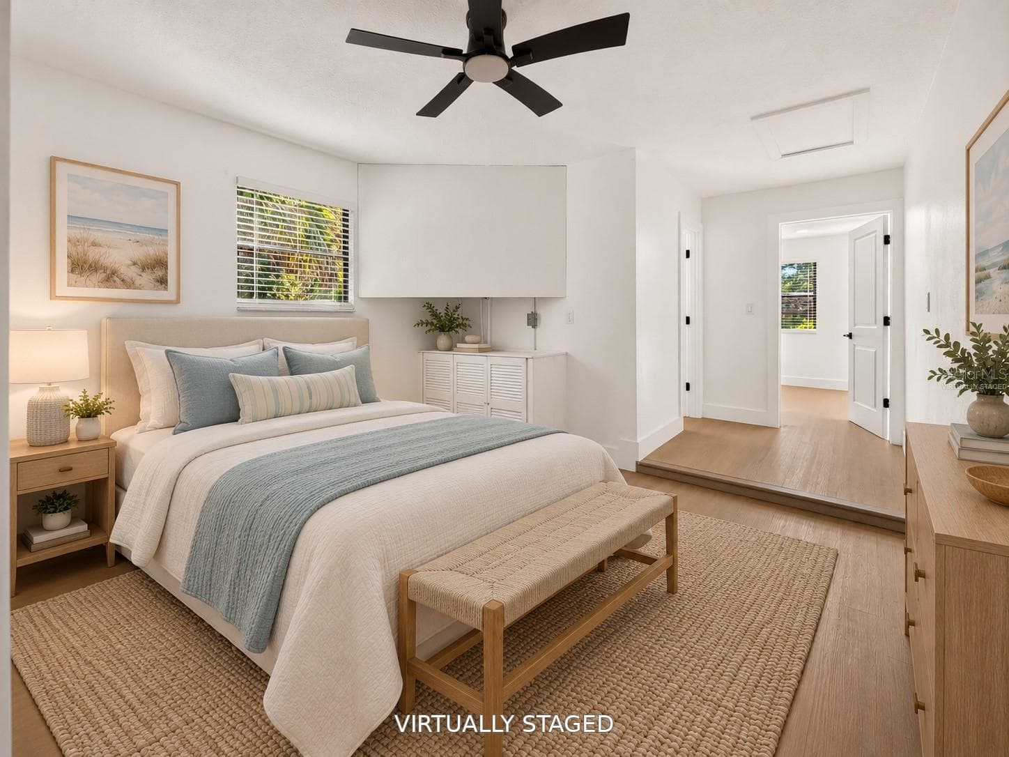 VIRTUALLY STAGED. Bright secondary bedroom featuring updated flooring and a modern black ceiling fan. - 16107 SEA PINES DR, HUDSON