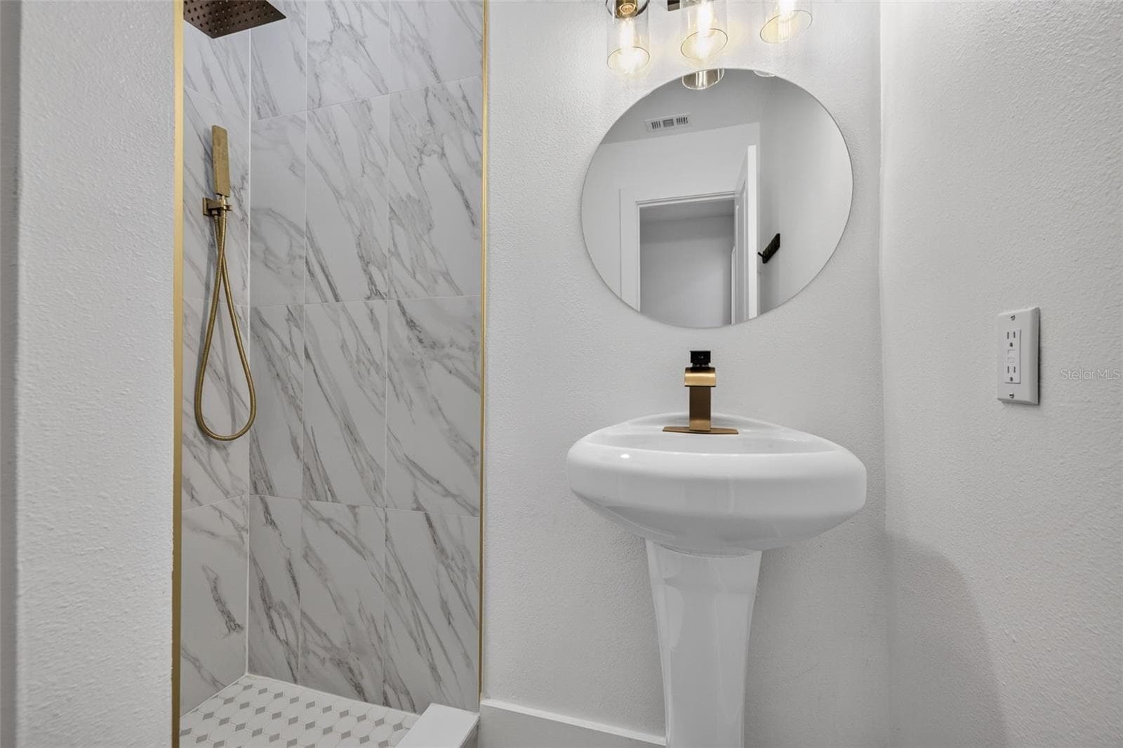 Thoughtful updates and contemporary details bring a fresh, modern feel to this private ensuite bathroom. - 16107 SEA PINES DR, HUDSON