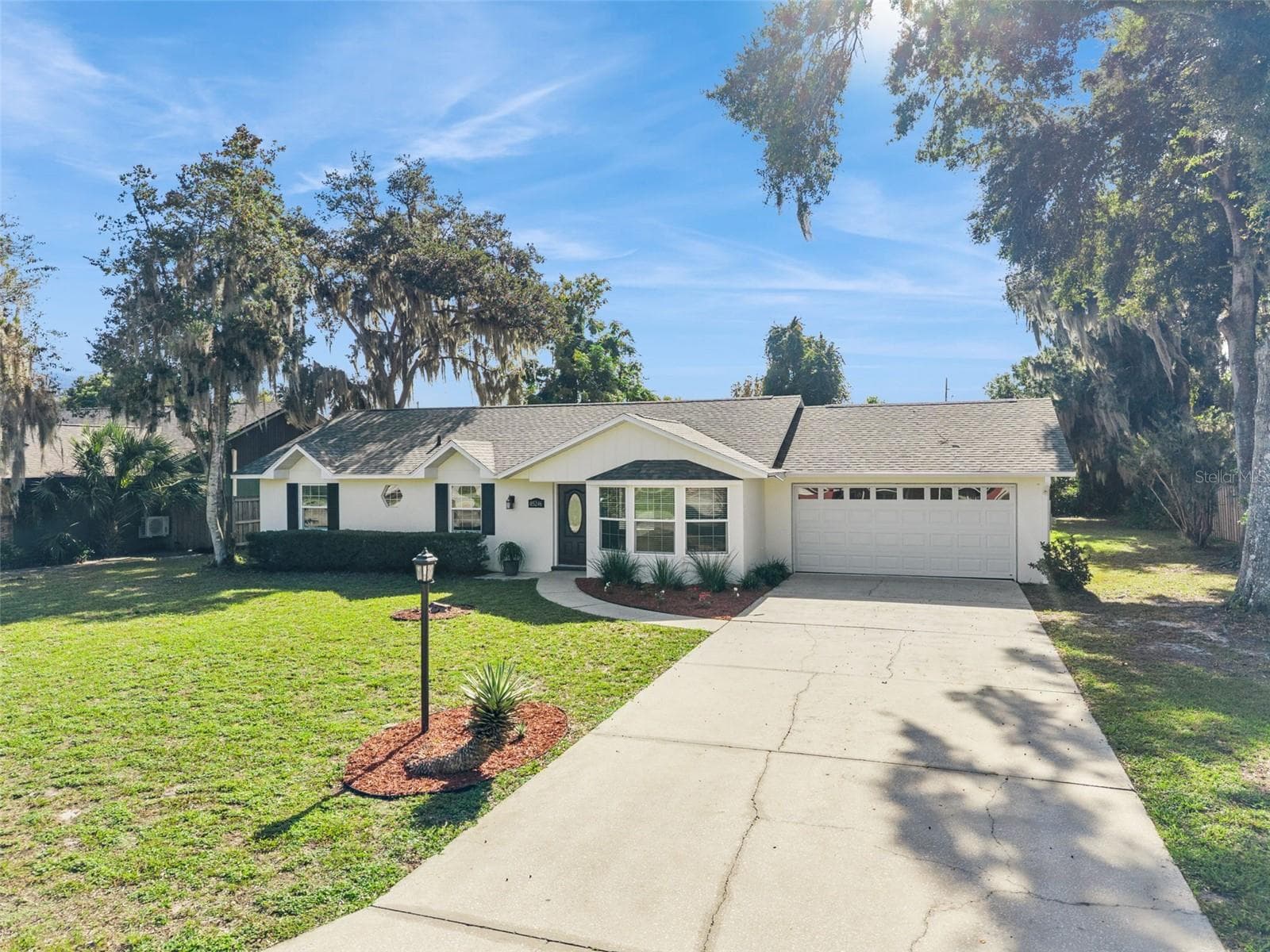 Two-car garage, wide driveway and fresh landscaping - 5246 ROYAL OAK DR, FRUITLAND PARK