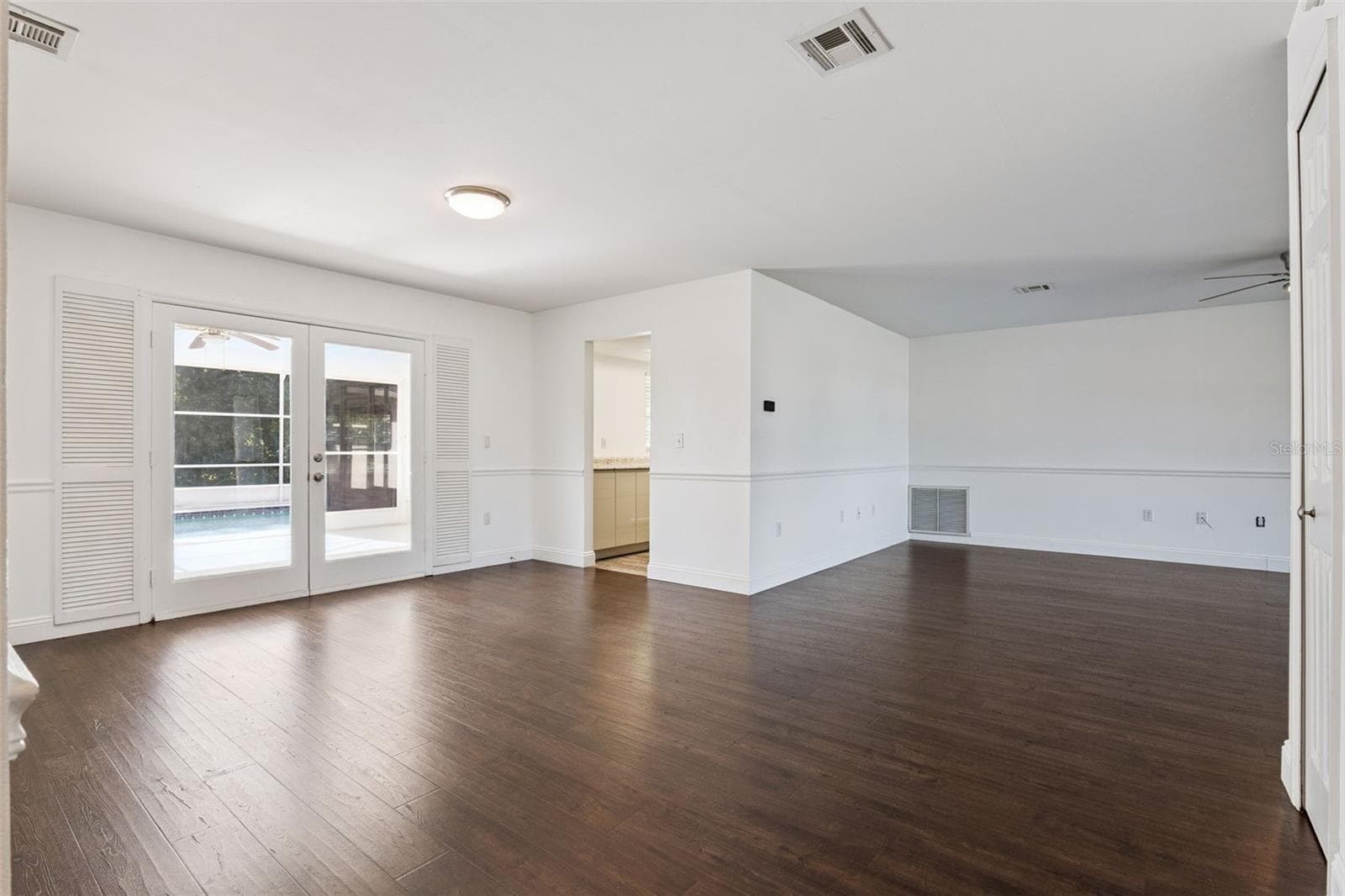 Natural light pours in through the French doors - 5246 ROYAL OAK DR, FRUITLAND PARK