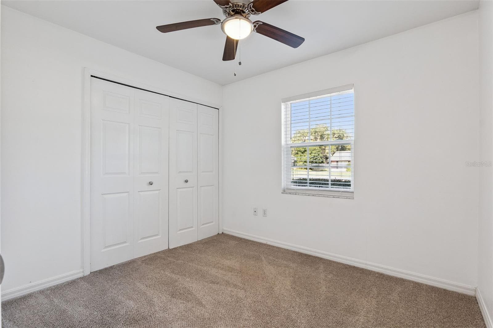 Bright bedroom with a double closet - 5246 ROYAL OAK DR, FRUITLAND PARK